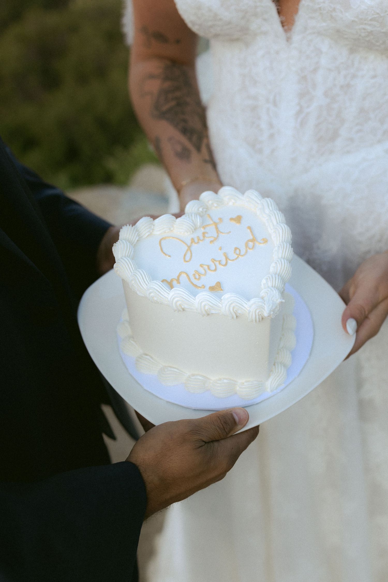 Couple holds heart-shaped Just Married cake at outdoor Yosemite elopement.