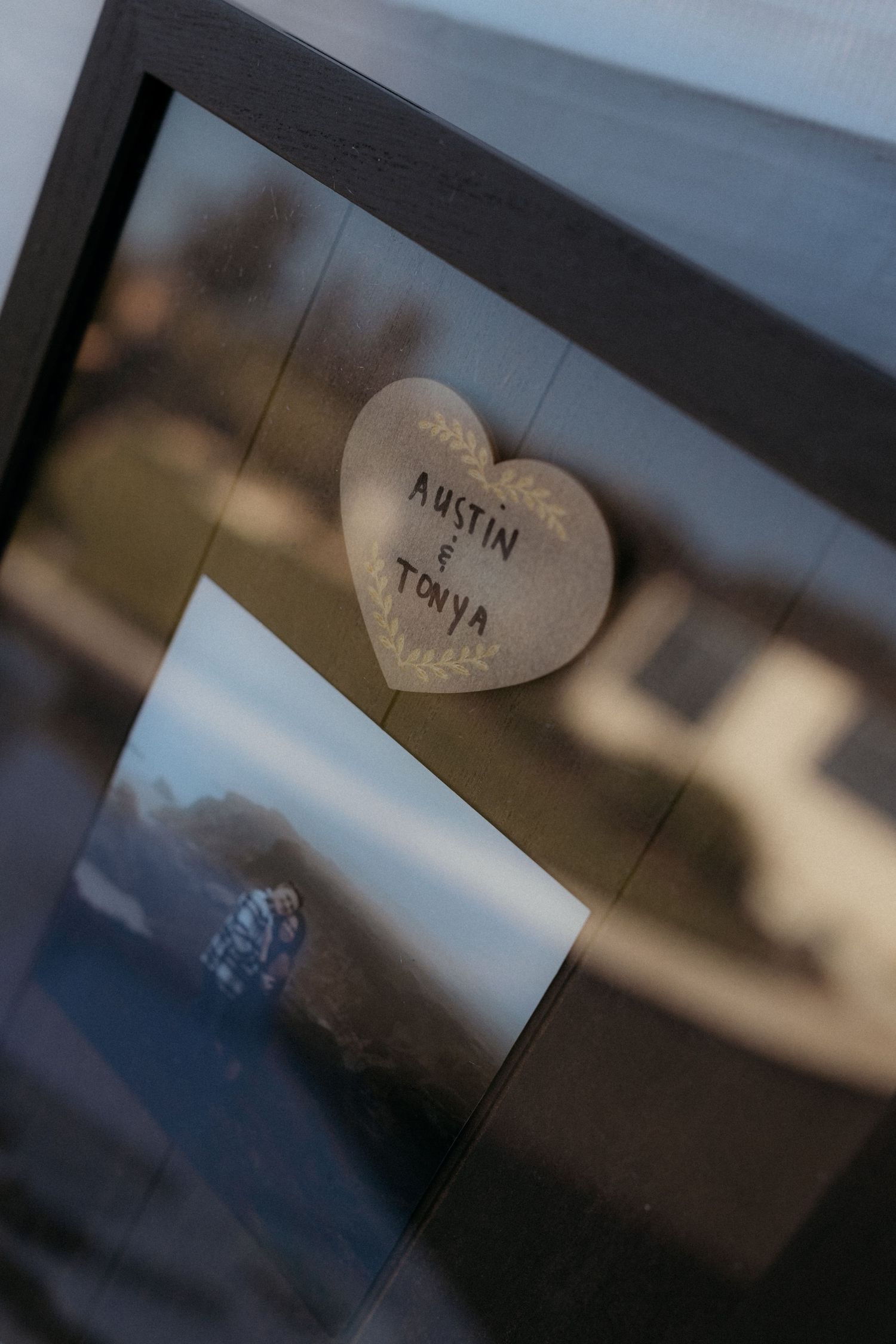 Small wooden heart-shaped name tags arranged for a wedding celebration.