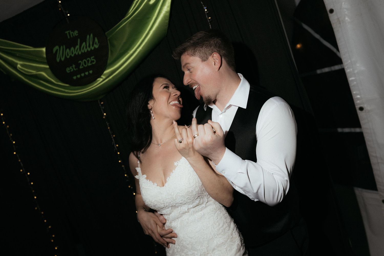 A romantic couple in formal wedding attire shares an intimate dance moment during their wedding reception.