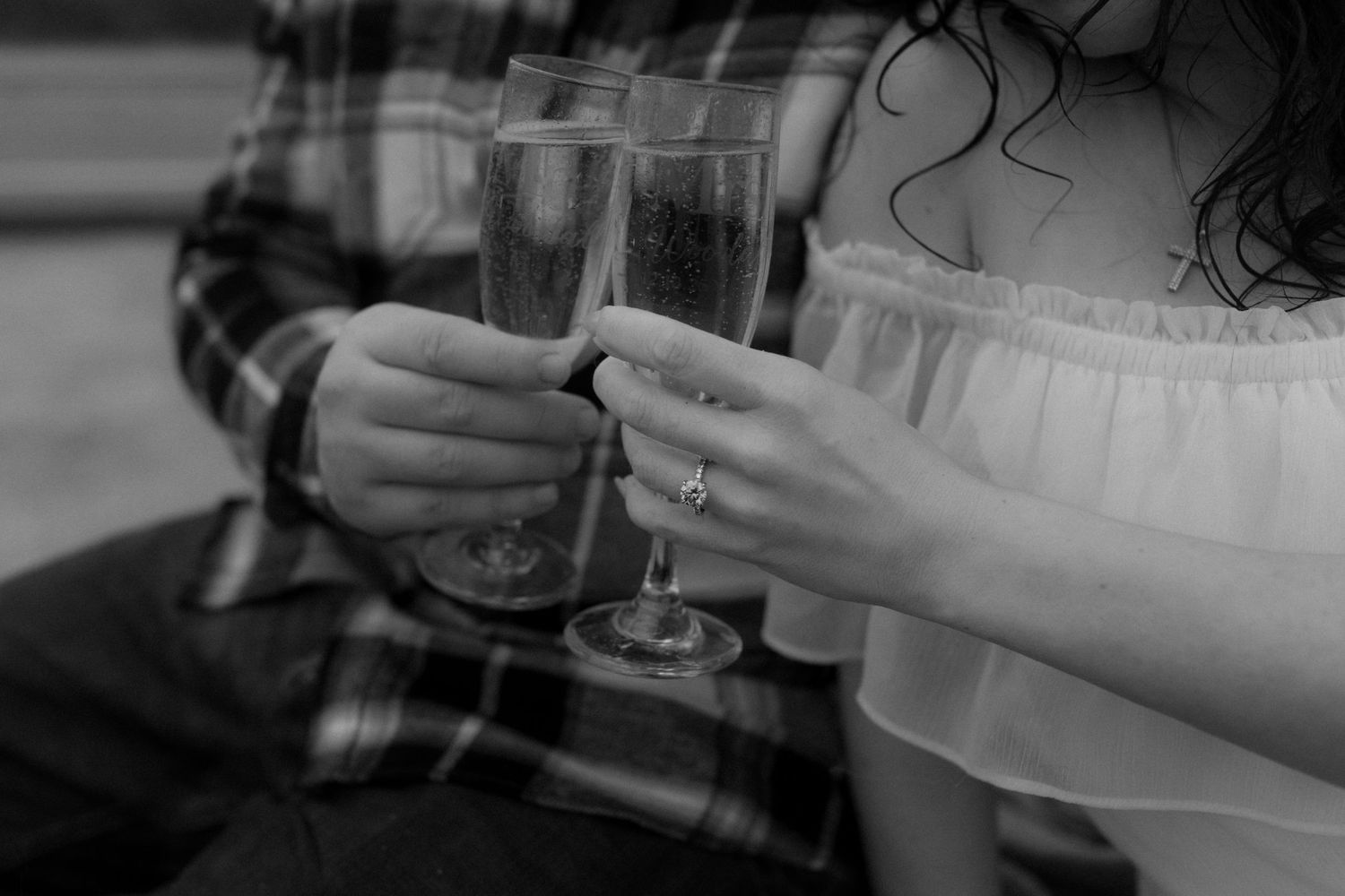 Romantic couple sharing drinks while relaxing in pickup truck bed.
