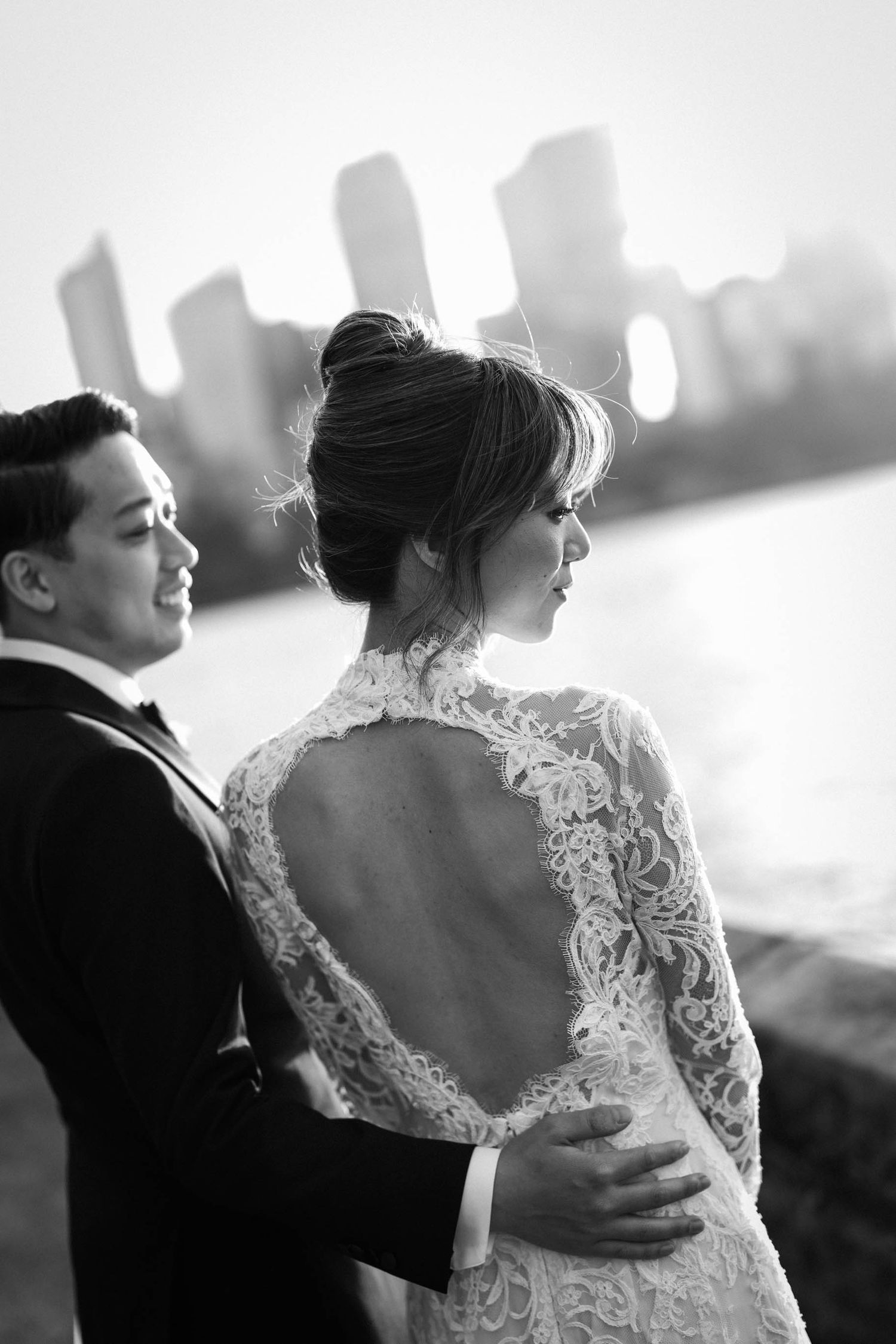 A romantic black and white sequence of newlyweds embracing by the water during their waterfront wedding photoshoot.