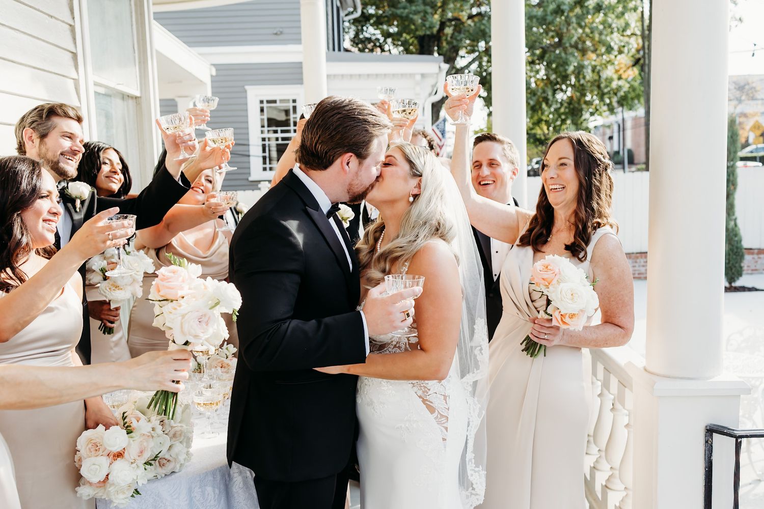 wedding kiss with bridal party