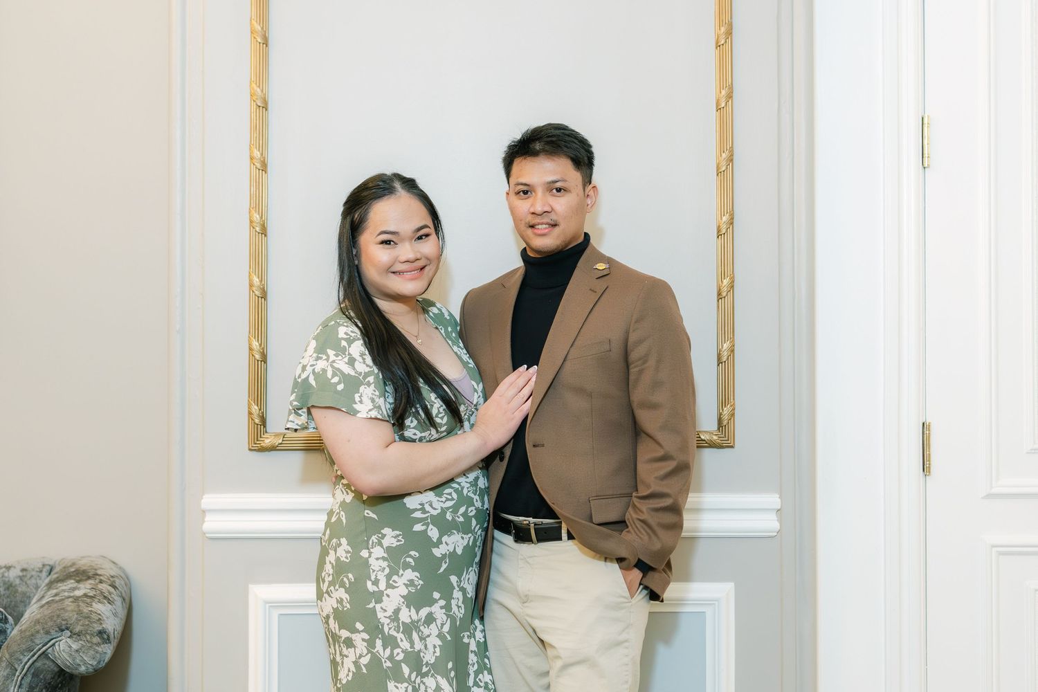 Couple celebrating their wedding anniversary with their children, posing together in front of a scenic backdrop and radiating love and joy