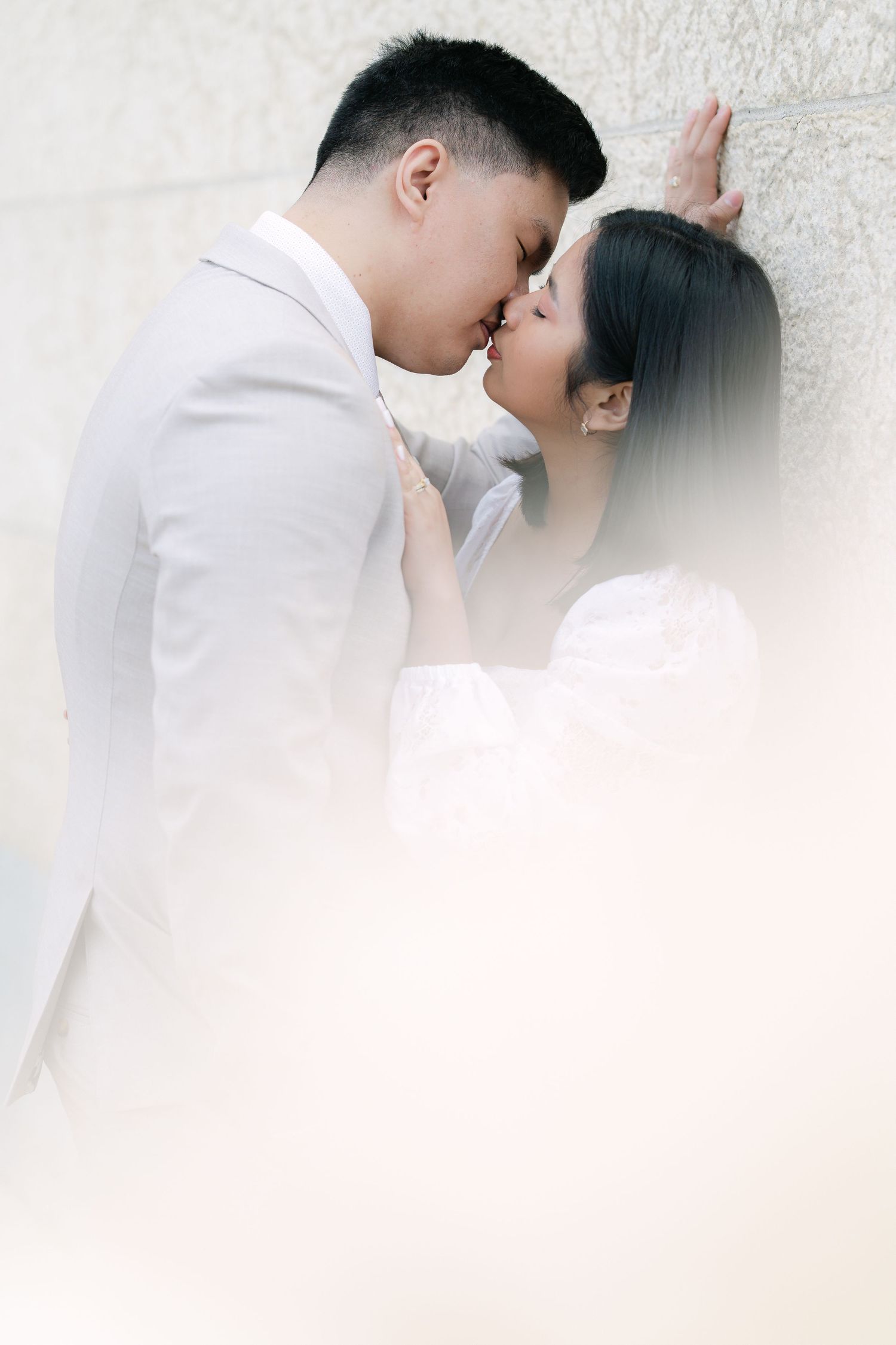 bride and groom sharing an intimate moment framed by soft wedding veiling