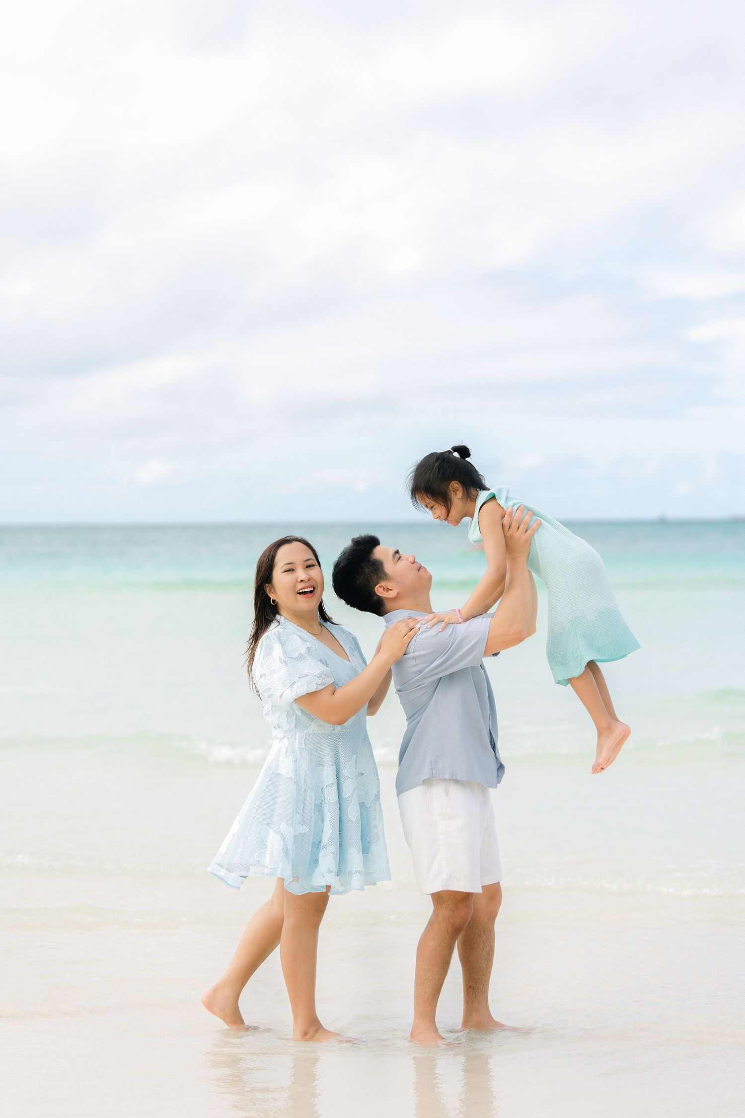 couple sharing a joyful moment by the ocean during a relaxed lifestyle portrait
