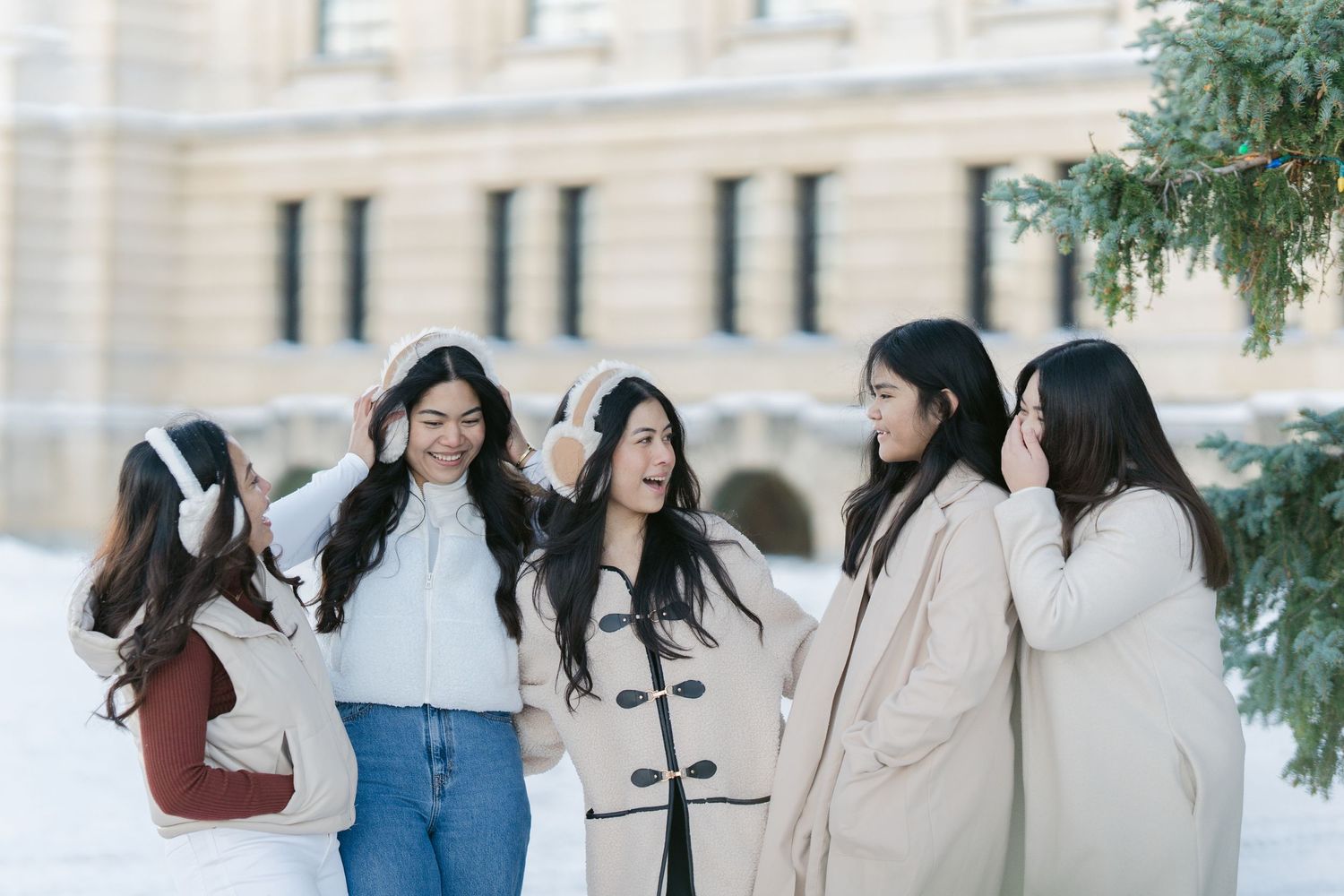 Candid photo of a family laughing and playing together in the snow, capturing a joyful moment during their photoshoot