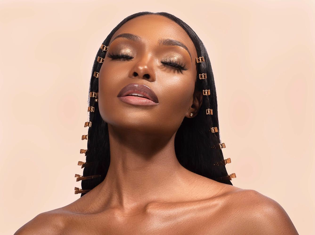 A beauty portrait series showing four different poses with glossy makeup and dramatic lighting against a pink background.
