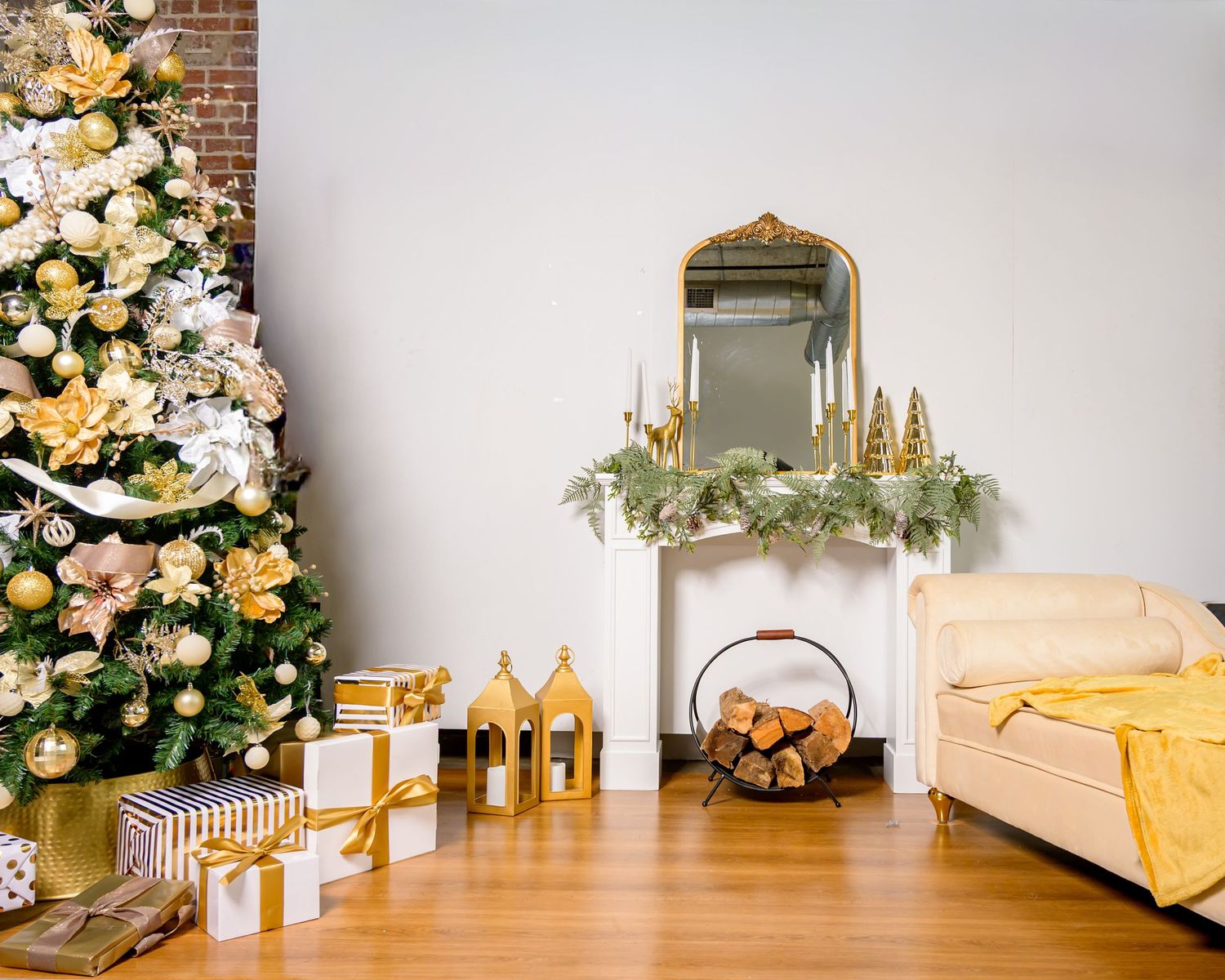 Elegant white and yellow floral arrangements decorate a modern interior space with brick walls and gold accents.