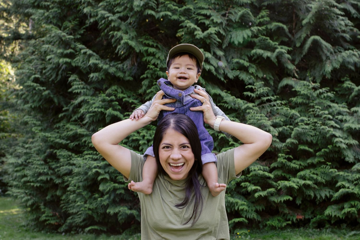 Joyful outdoor shoulder ride with baby against green forest backdrop.
Central Park Burnaby