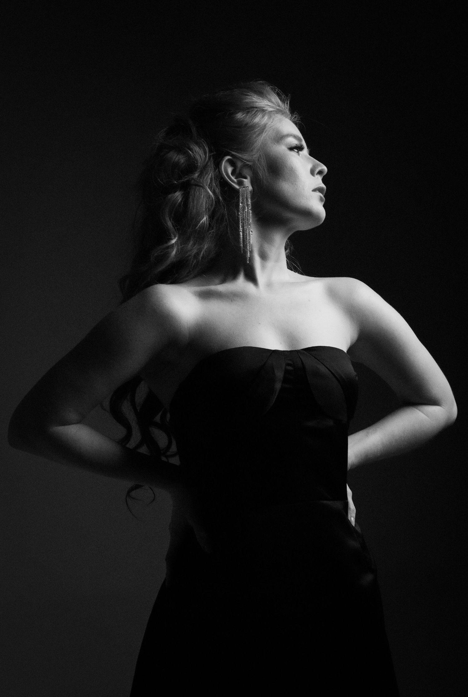 Dramatic black and white portrait of woman in strapless dress.