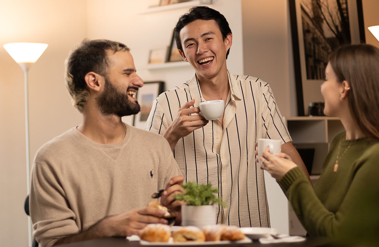 Group enjoying coffee and conversation at a casual indoor gathering.