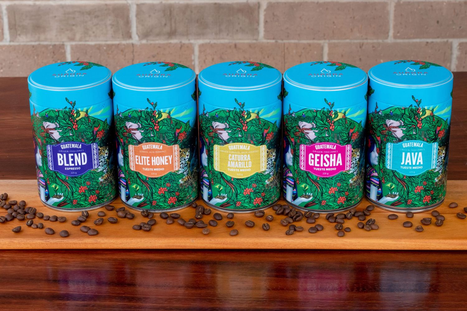 Row of colorful tea tins displayed on wooden surface with branded packaging design.
