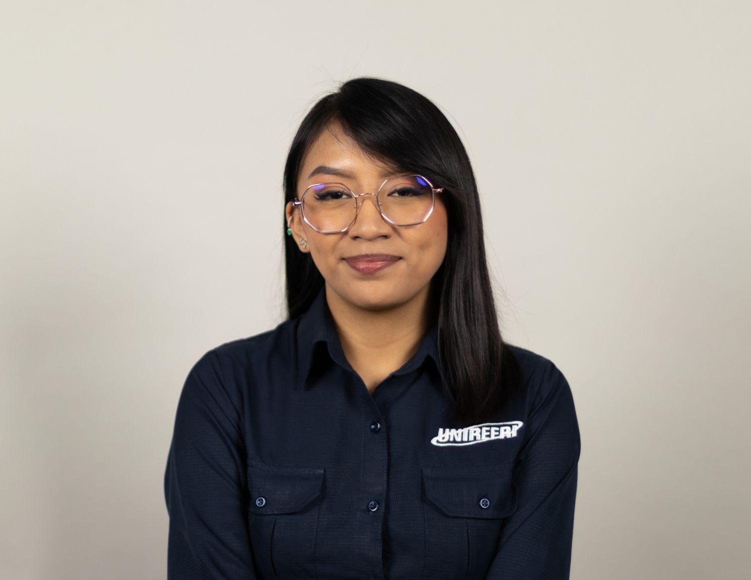 Employee portraits showing person in dark uniform with company branding.