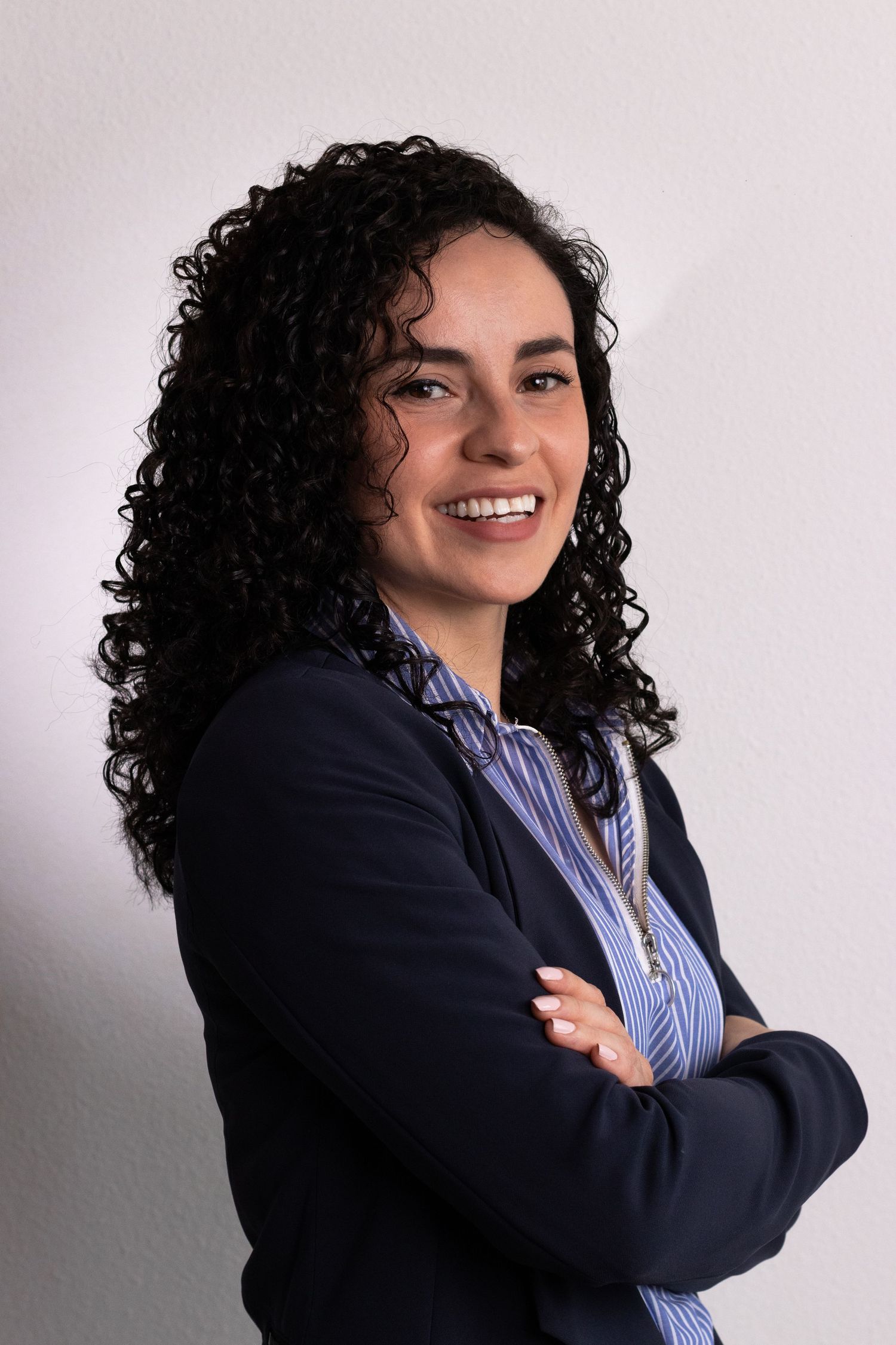 Studio portraits showing business attire with navy blazer against white background.