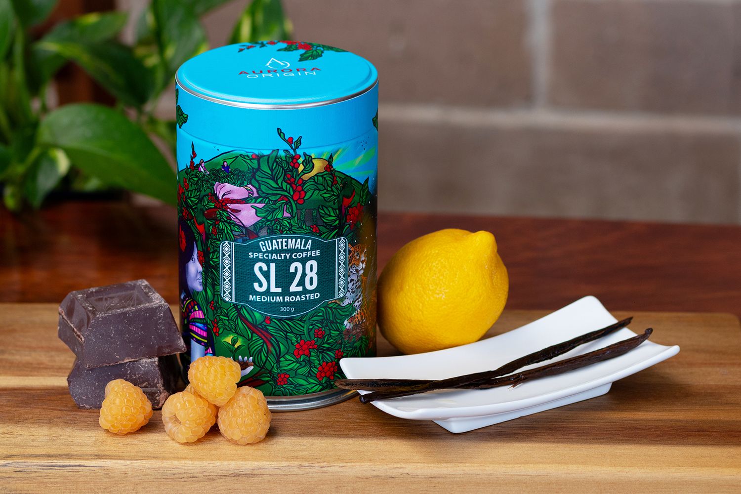 Bright blue coffee tin container with tropical design pattern displayed on wooden surface.