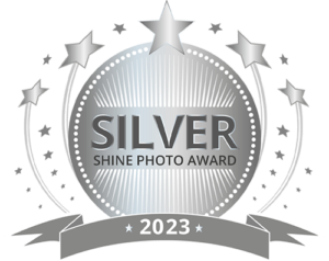Silver Shine Photo Award 2023 badge with stars and ribbon emblem.