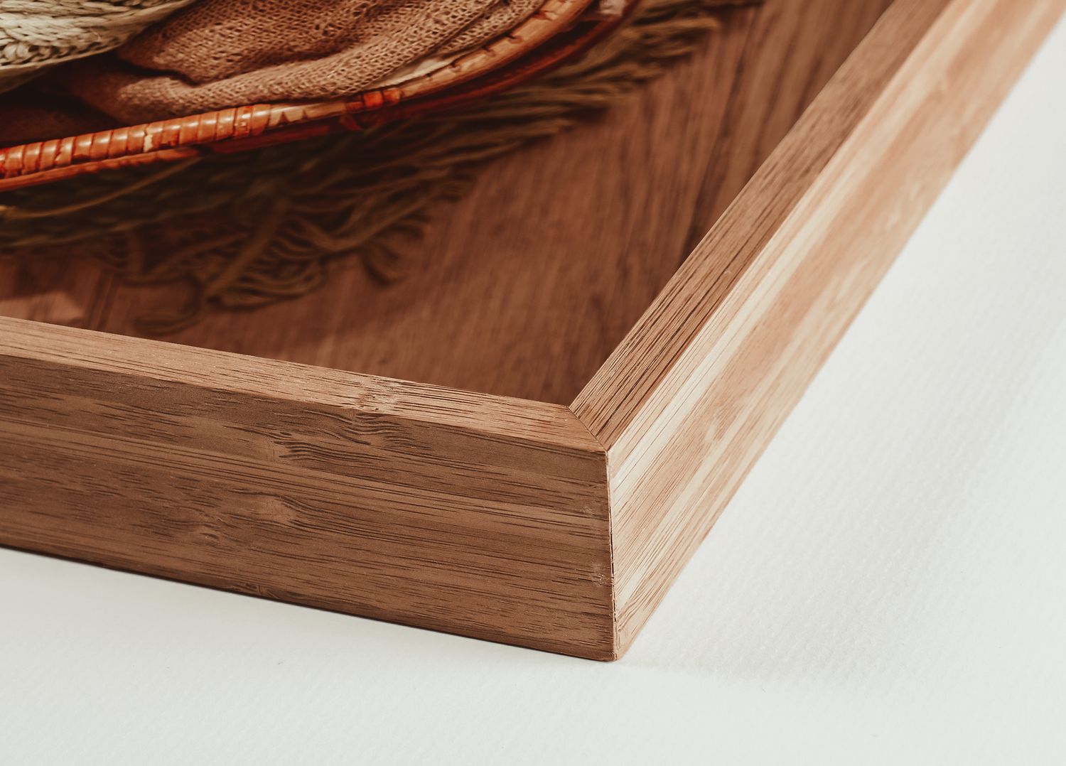 Close-up of a wooden frame corner showcasing walnut and bamboo layered construction with fine craftsmanship.