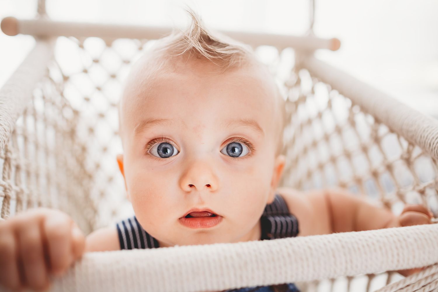 Blue eyed baby boy in swing for session in Angleton Tx studio