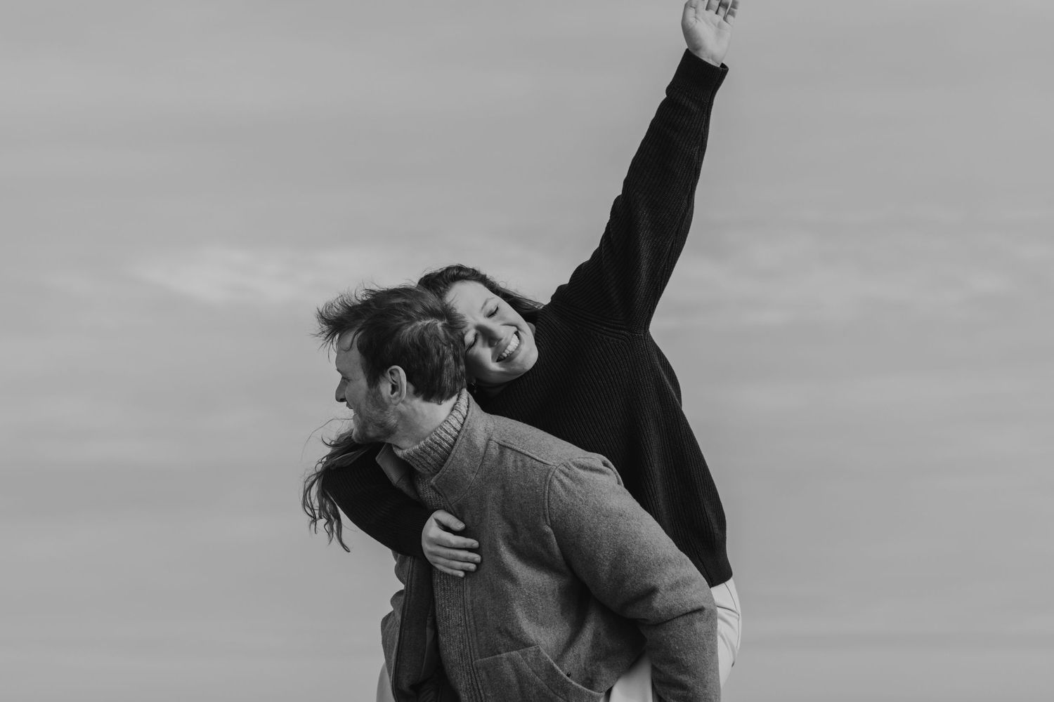 A series of black and white photos shows a couple performing romantic dance lifts and poses together.