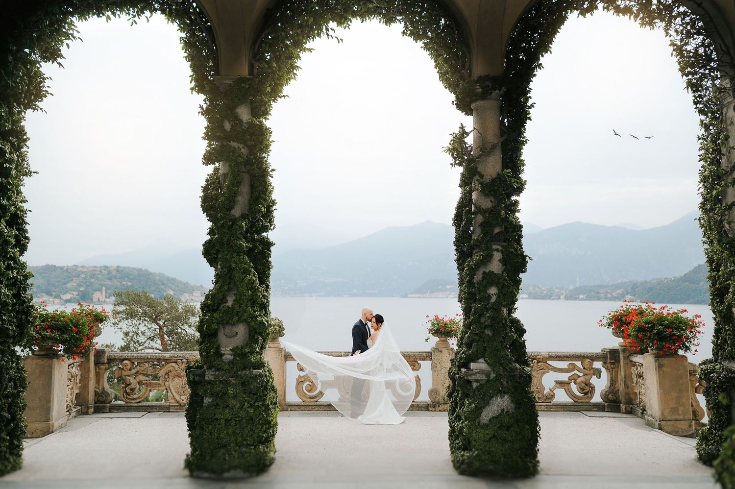 Bride and groom under villa arches during Lake Como wedding
at Villa Balbianello