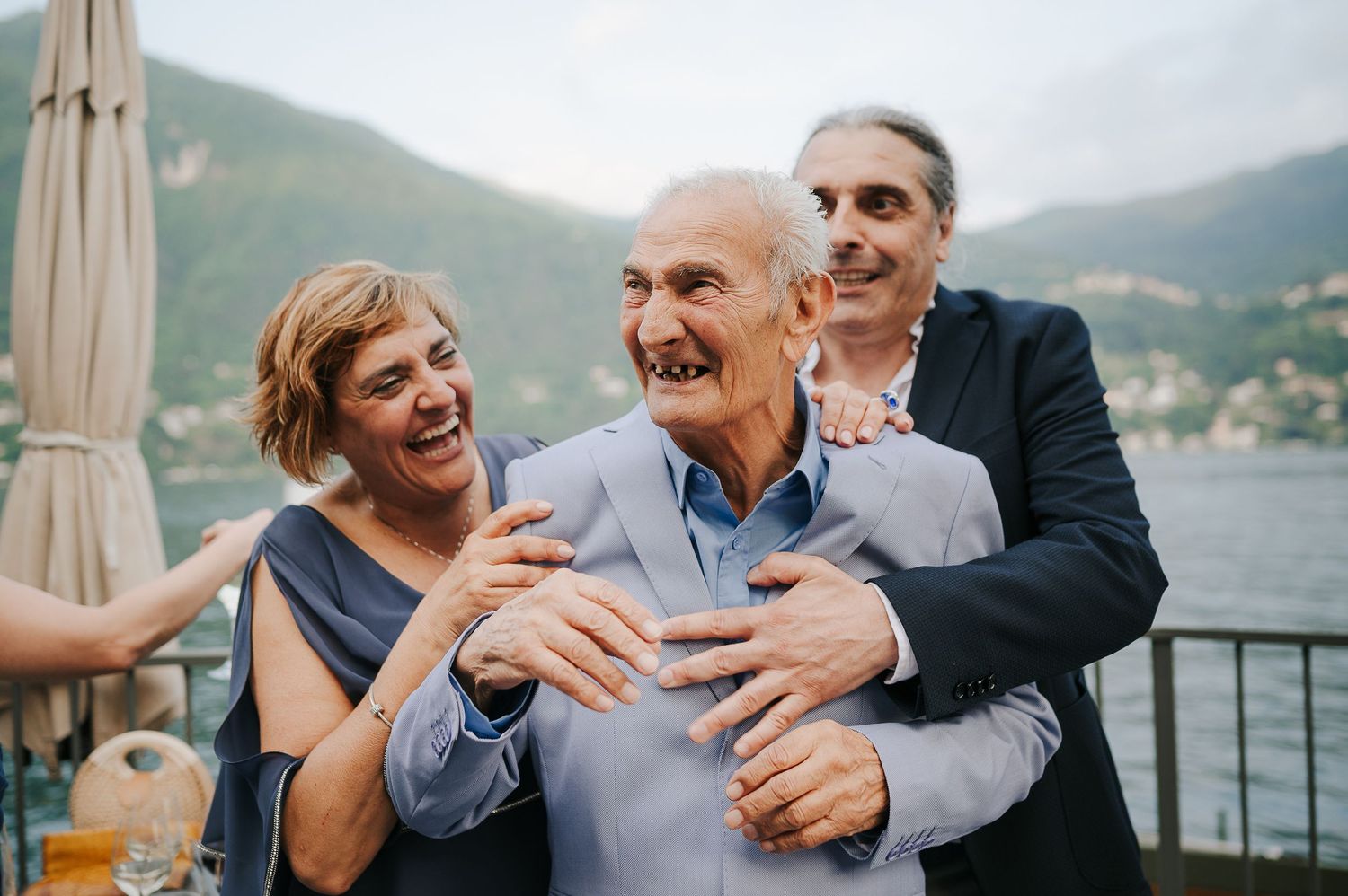 Joyful welcome party moment during a luxury destination wedding at Grand Hotel Tremezzo on Lake Como