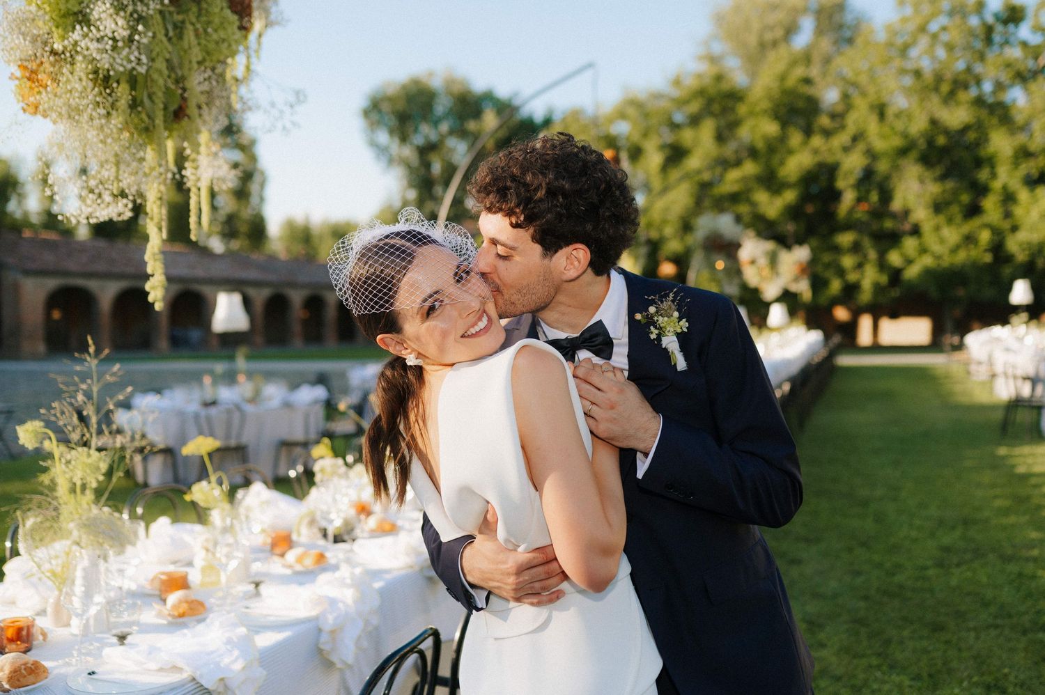 Intimate moment between bride and groom during a refined outdoor wedding reception in Tuscany
