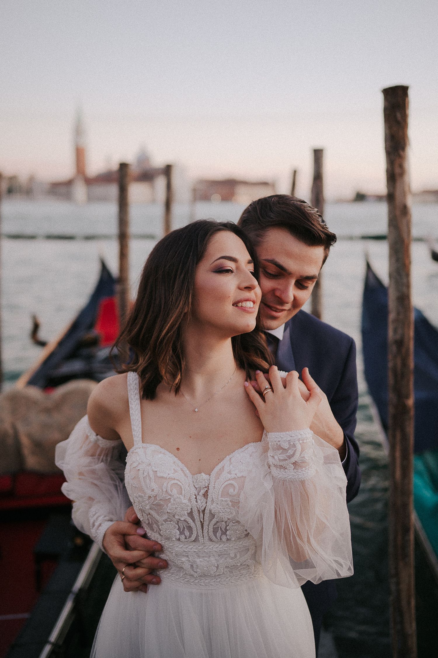 Post-wedding couple portrait in Venice, Italy, captured among gondolas with a refined editorial style