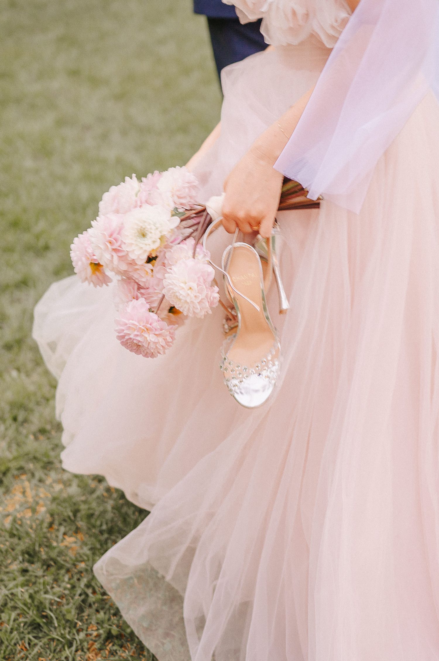 Wedding detail featuring bouquet and dress captured during an elegant celebration in Tuscany, Italy