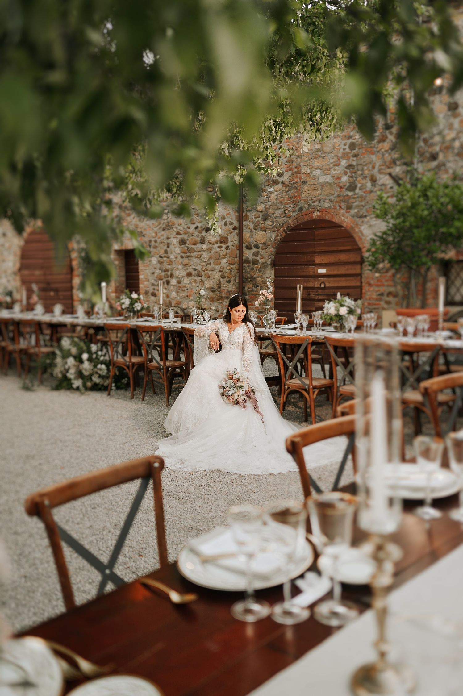 Elegant wedding table and bride captured during a refined destination wedding in Tuscany, Italy