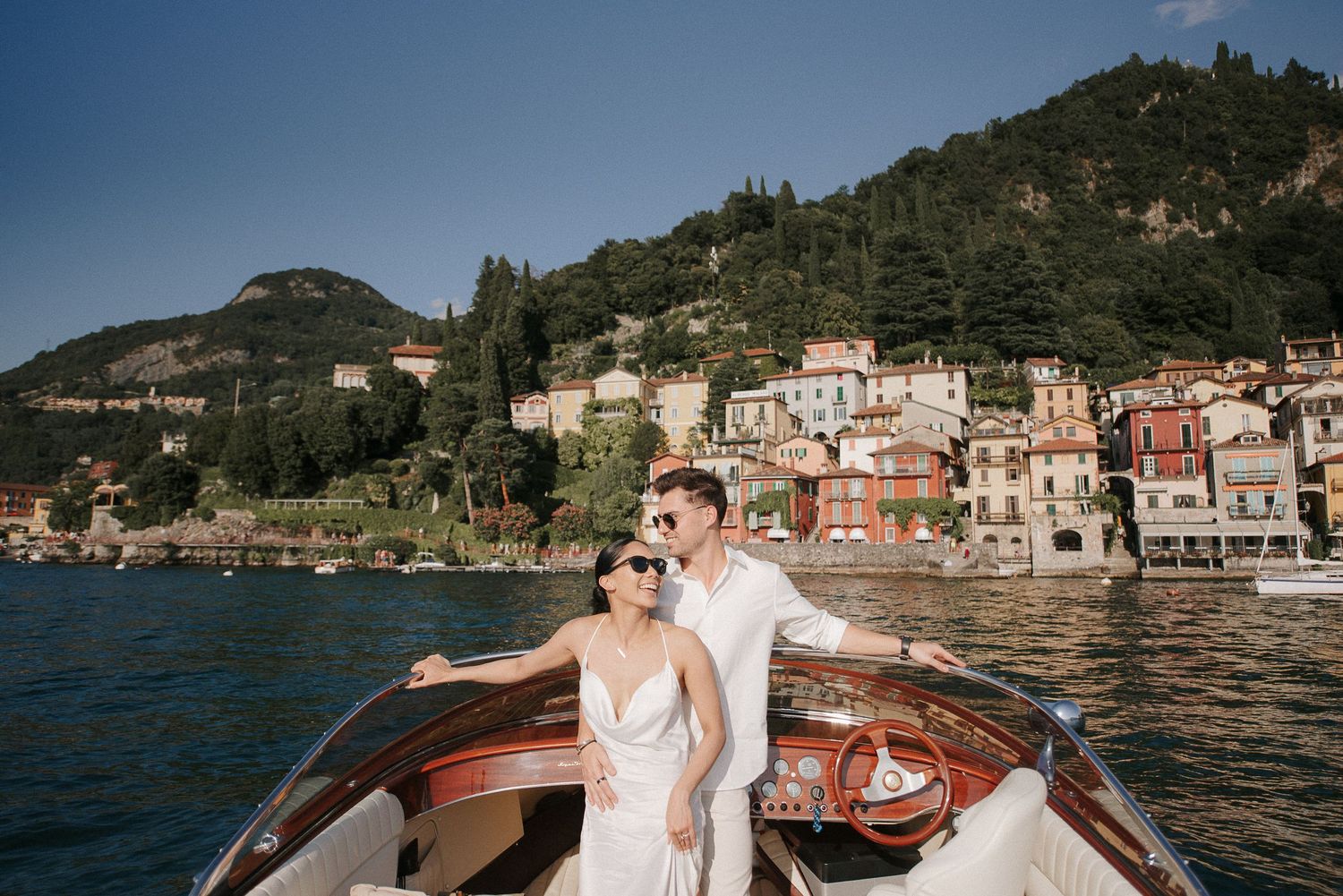 Couple enjoying a luxury boat ride on Lake Como during an elegant destination wedding