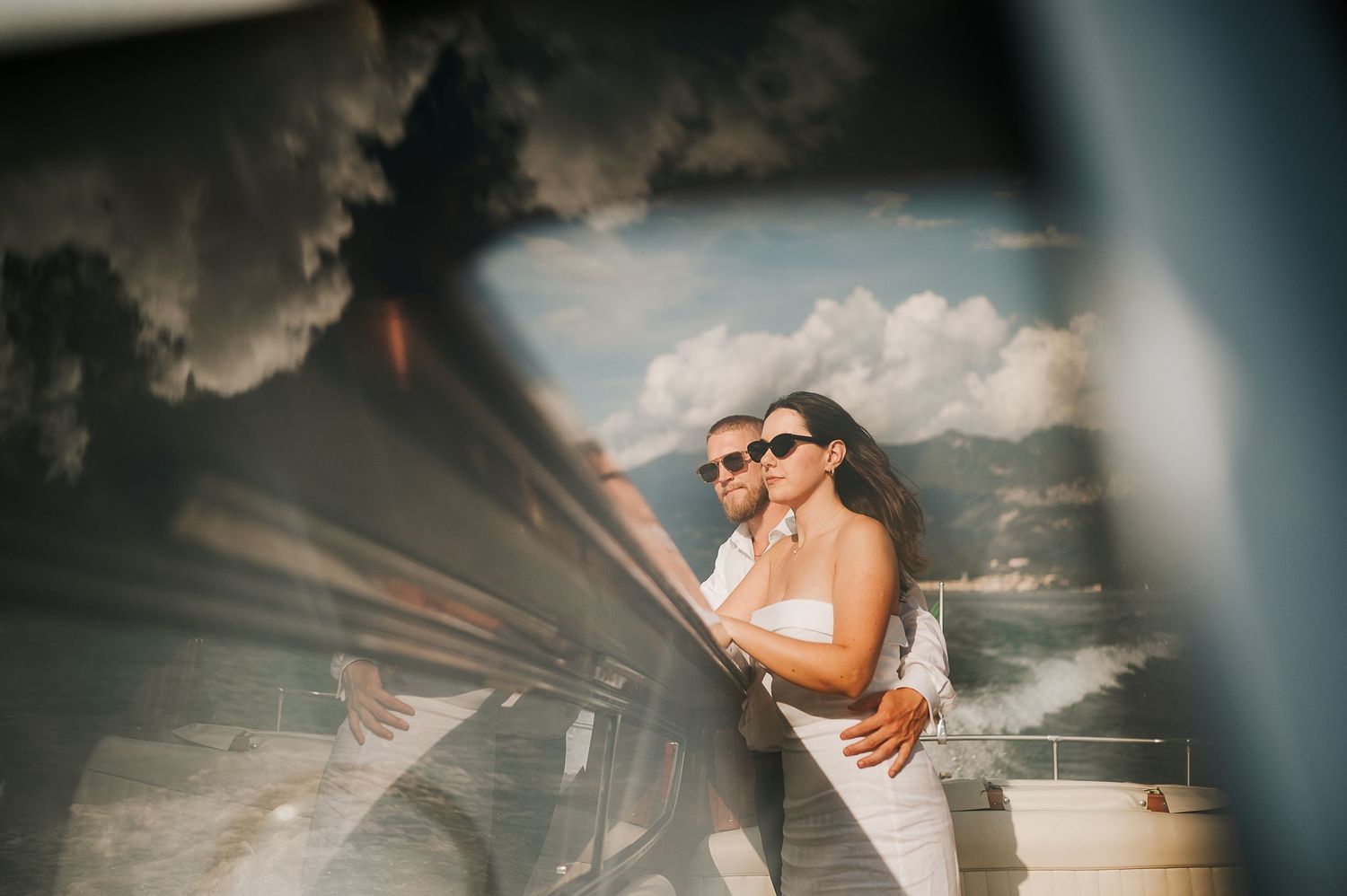Couple on wooden boat during Lake Como engagement in Varenna