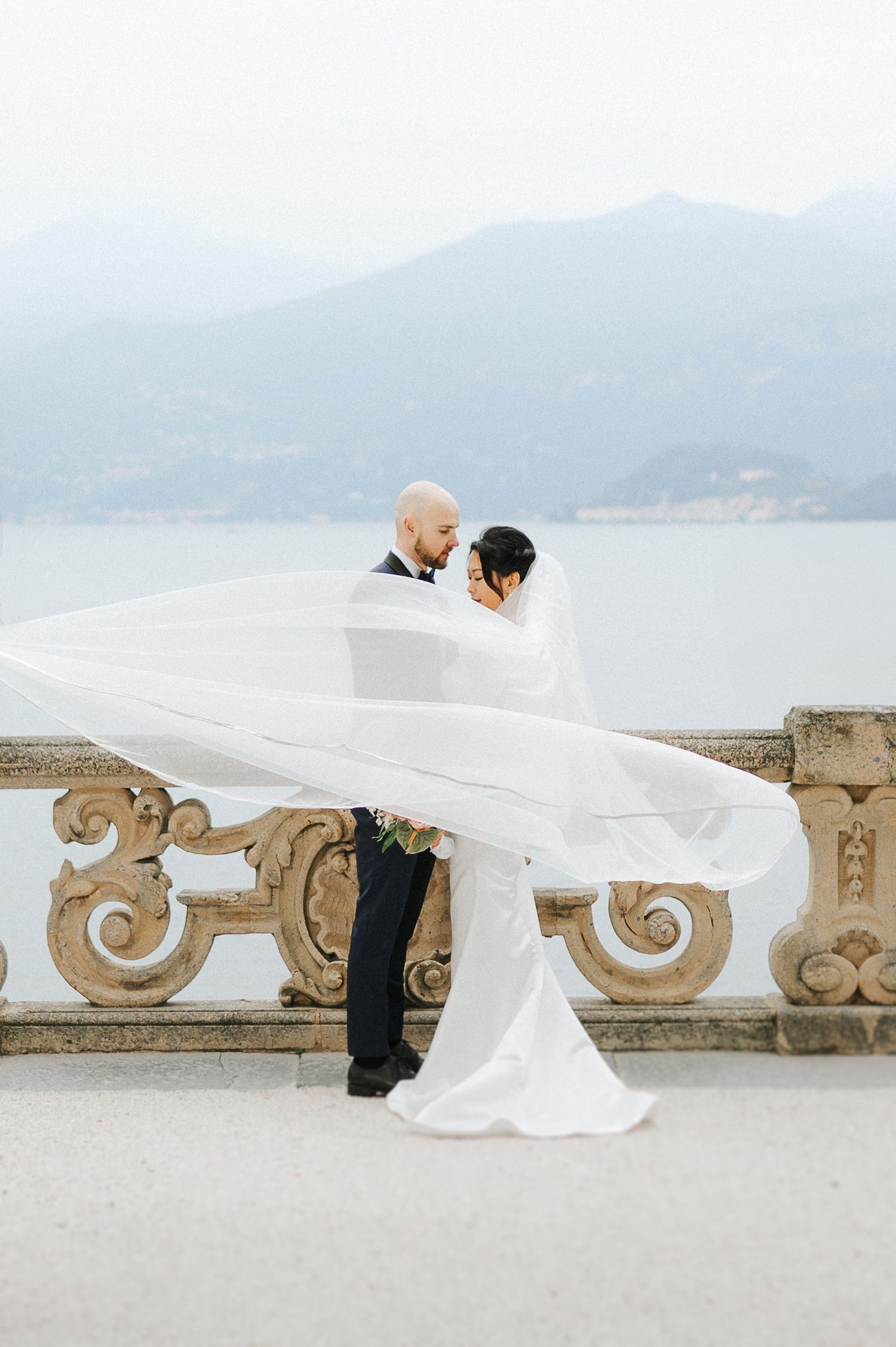 Elegant couple portrait with flowing veil captured during a luxury Lake Como wedding, Italy