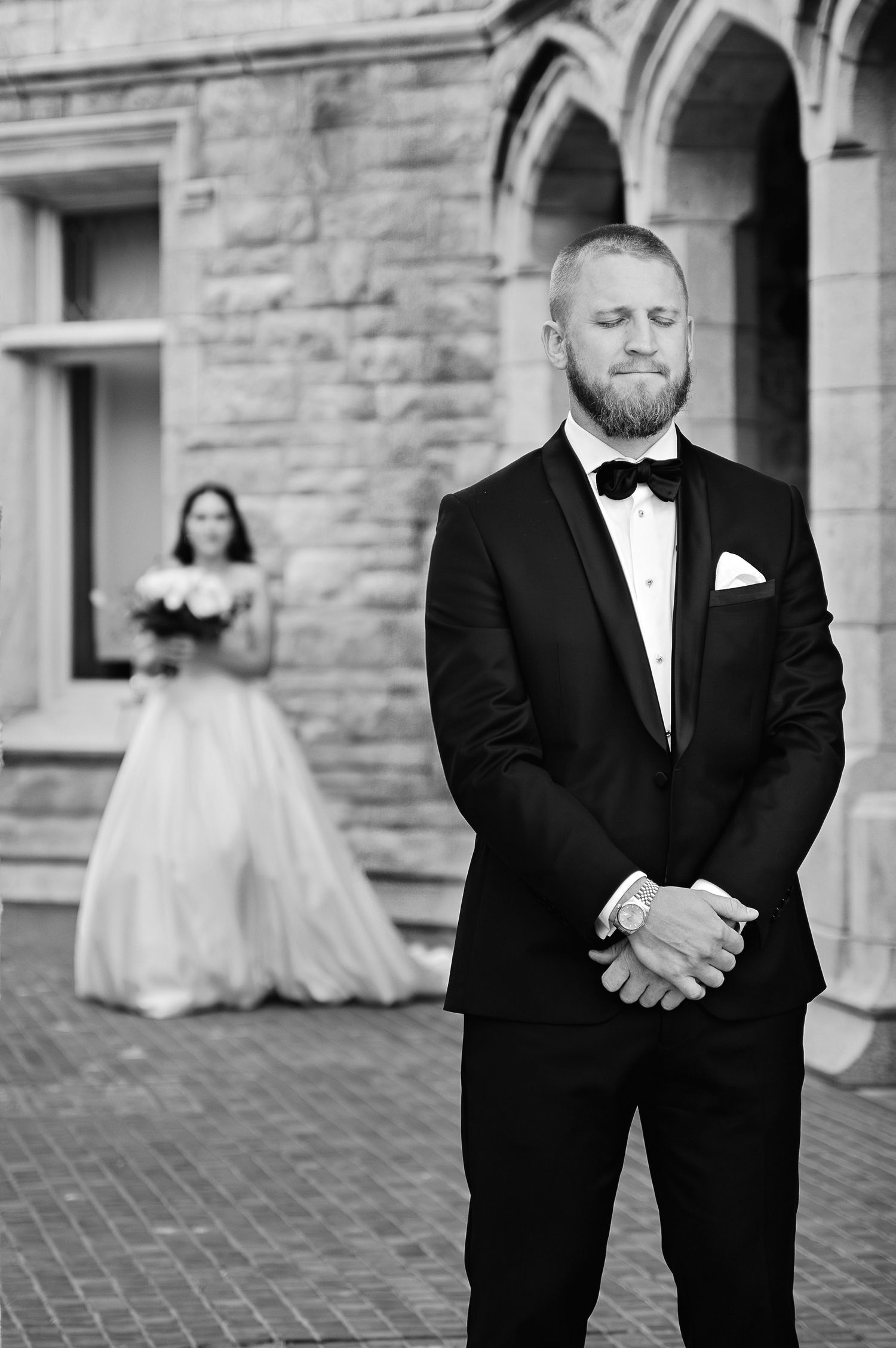 Editorial groom portrait in black and white capturing anticipation and quiet emotion before the ceremony