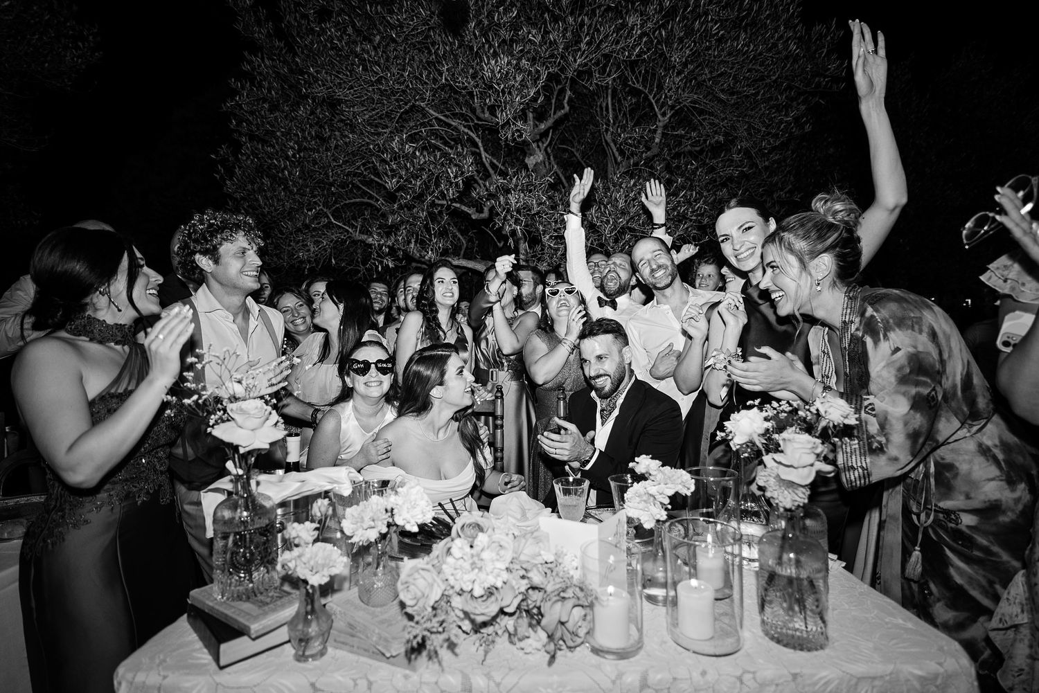 Joyful wedding celebration captured at night during a luxury destination wedding in Tuscany