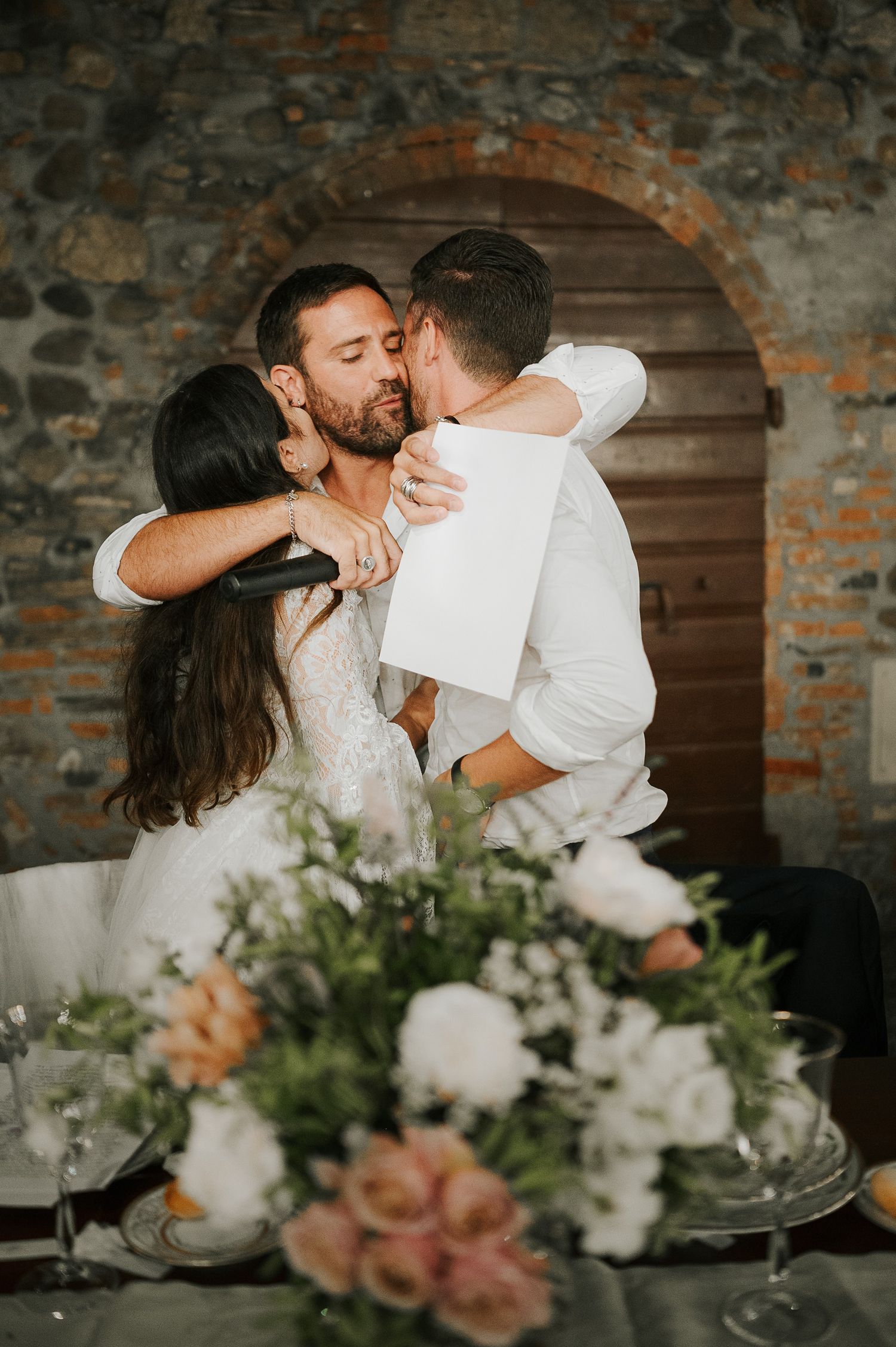 Bride and groom embracing during Tuscany wedding celebration