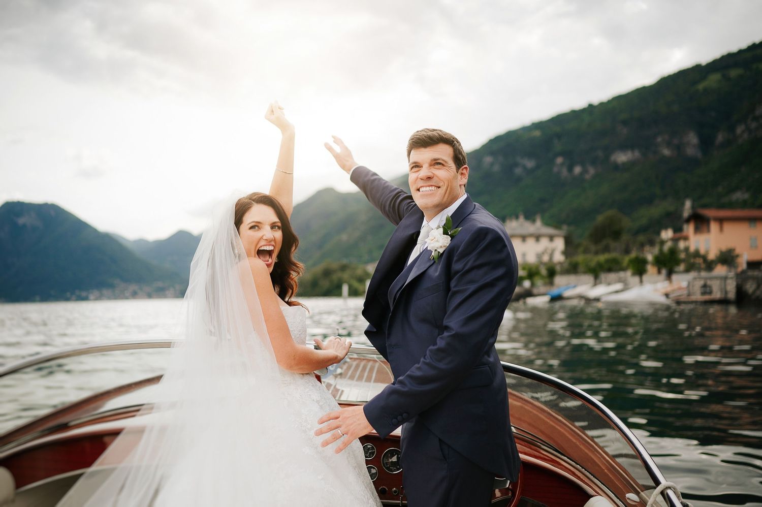 Luxury destination wedding on Lake Como, Italy, photographed during an intimate and joyful moment on the water