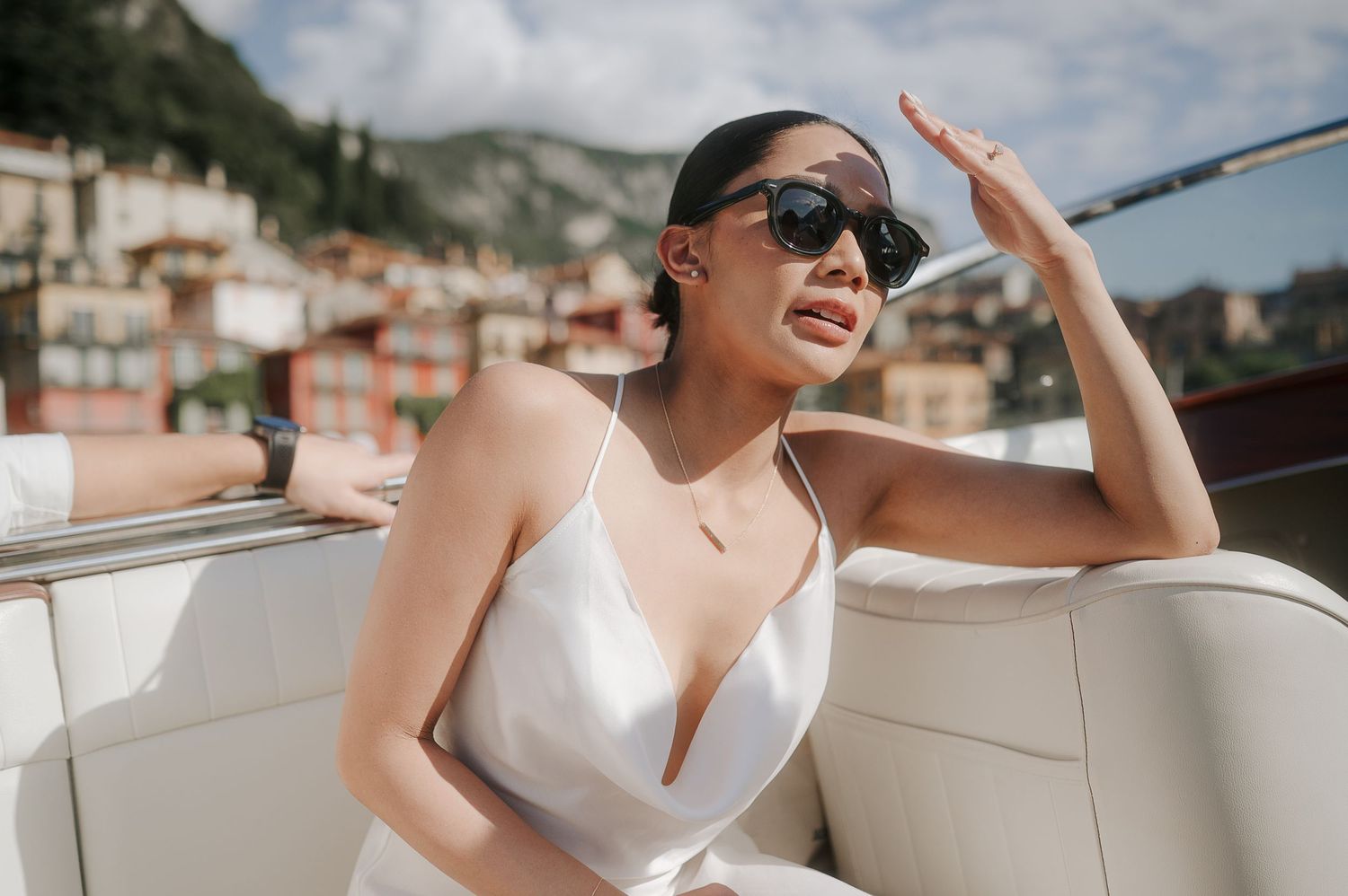 Elegant bride enjoying a luxury boat ride on Lake Como during a destination wedding experience