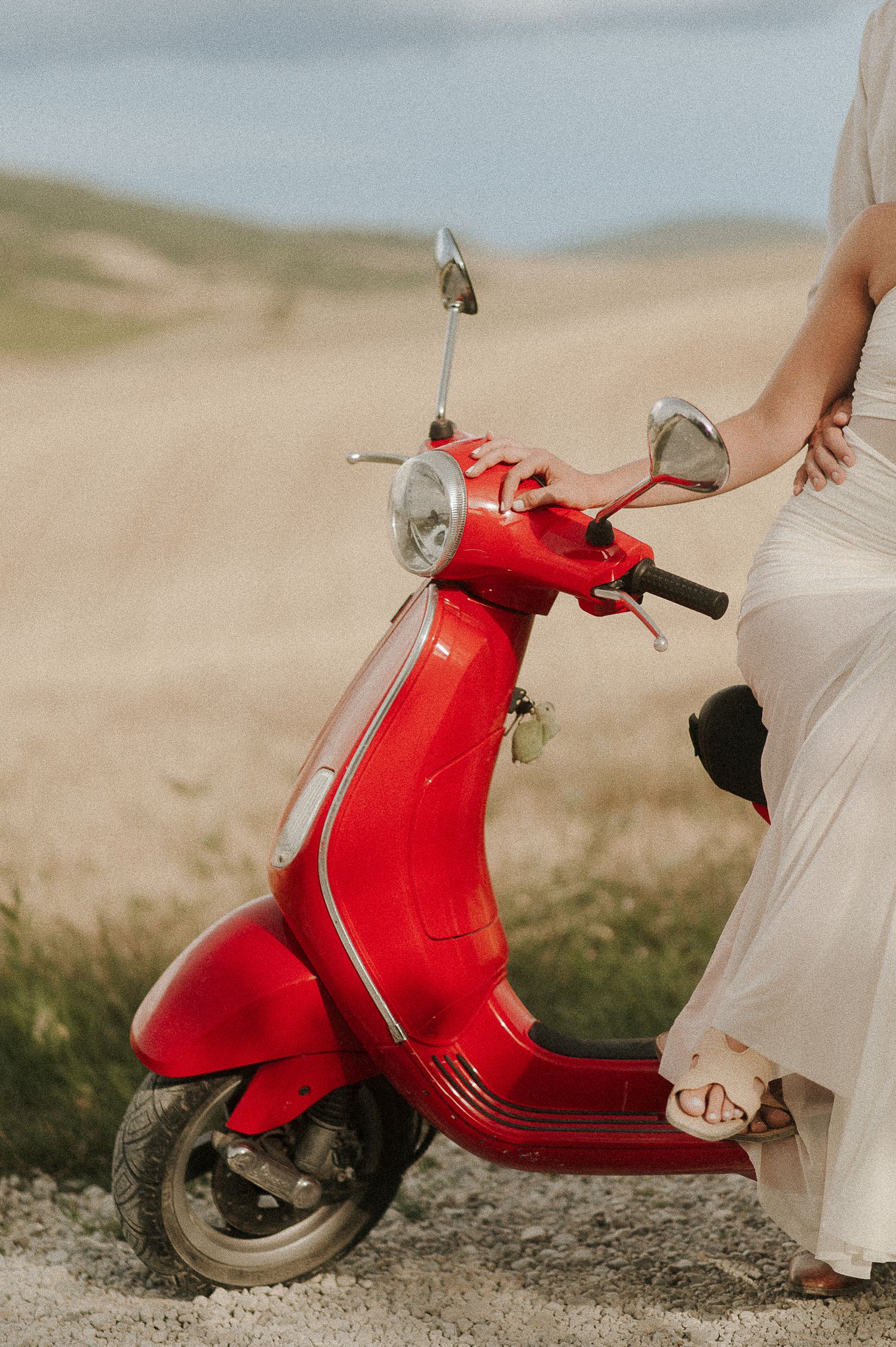 Engagement photoshoot with red Vespa in Tuscany countryside