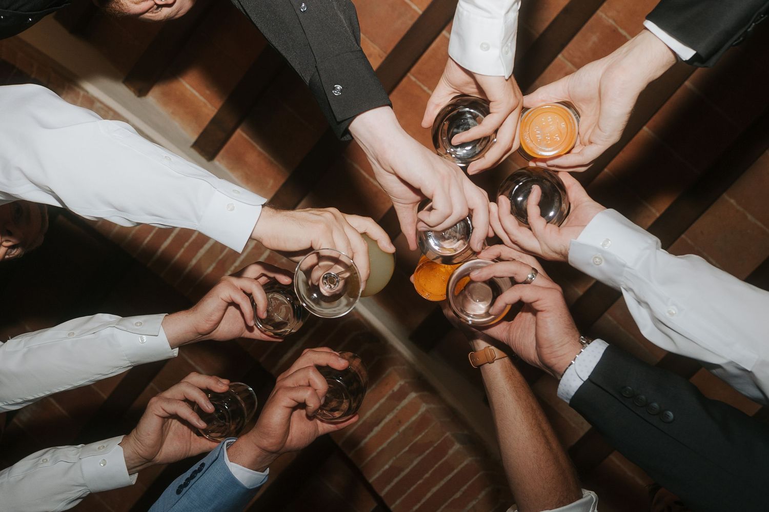 Wedding celebration toast captured from above during a luxury wedding in the Tuscan countryside