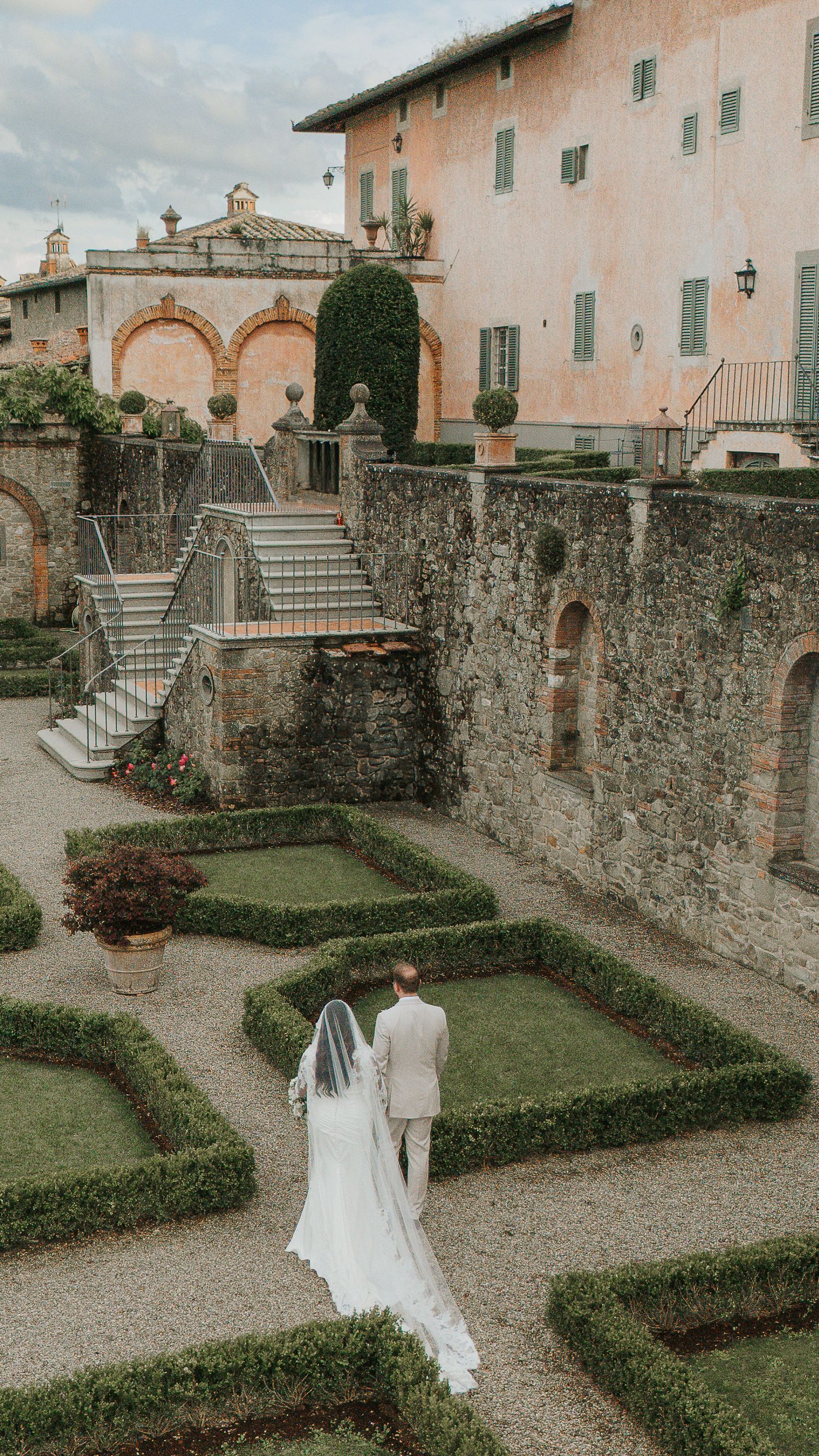Bride walking through historic Tuscan wedding venue garden
Villa barberino