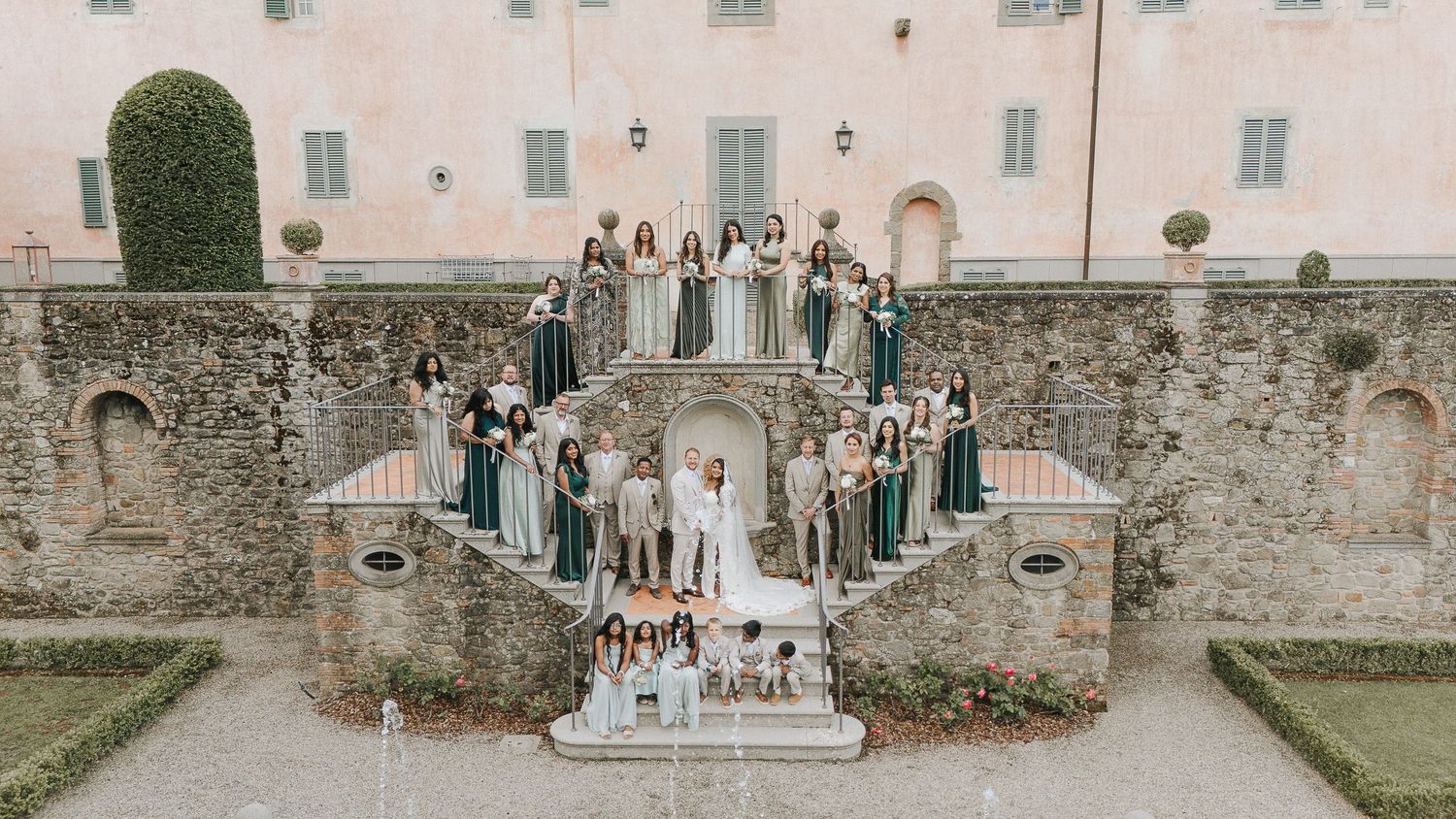 Wedding celebration set against historic Italian architecture, captured with a timeless editorial perspective
