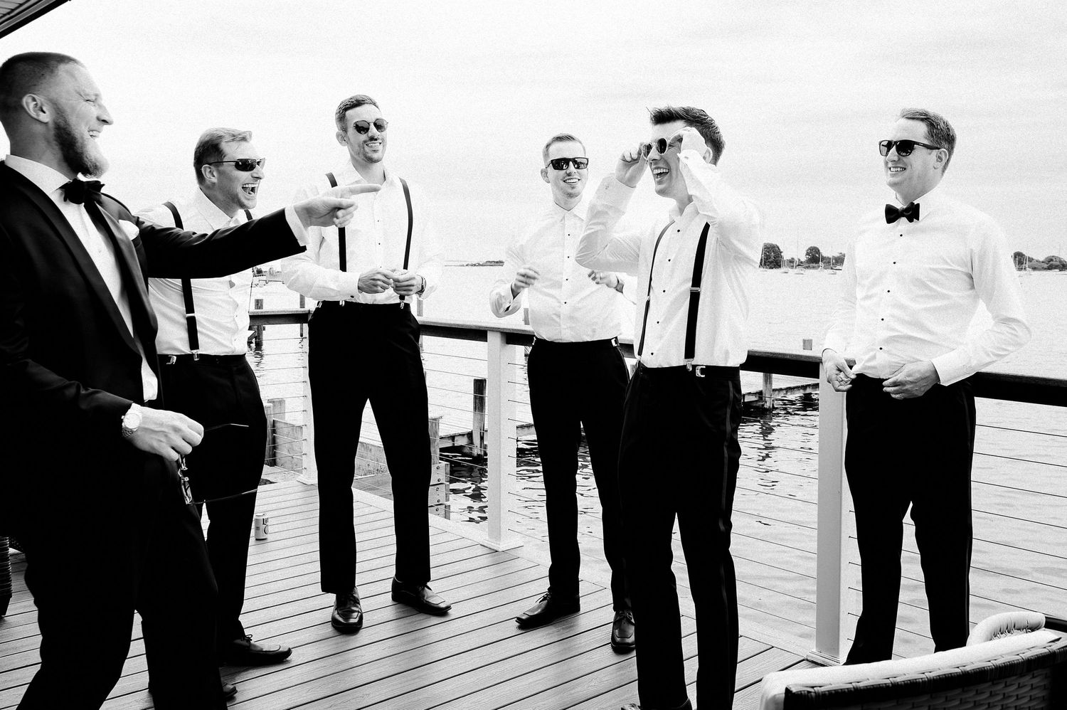 Candid wedding moment captured in black and white, highlighting connection and relaxed celebration