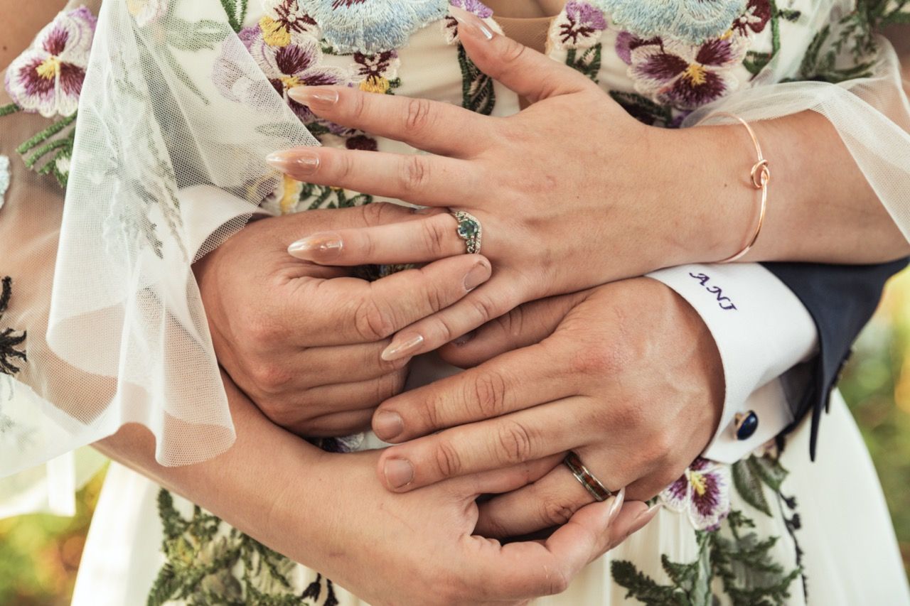 Couple showing off rings at wedding at June Norcross Webster Scout Reservation in Ashford, CT captured by illuminate the stars Photography