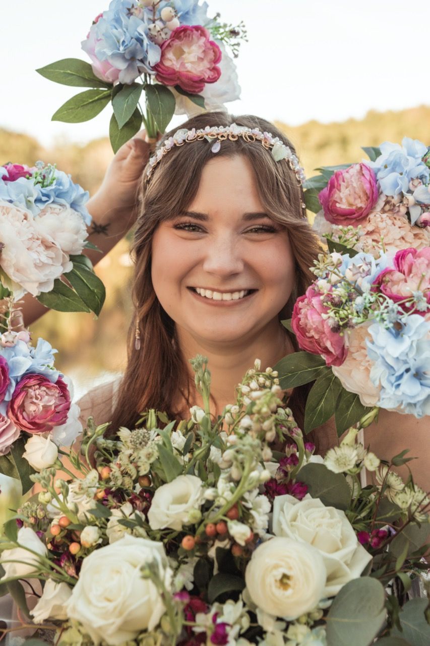 Bride surrounded by flower at wedding at June Norcross Webster Scout Reservation in Ashford, CT captured by illuminate the stars Photography