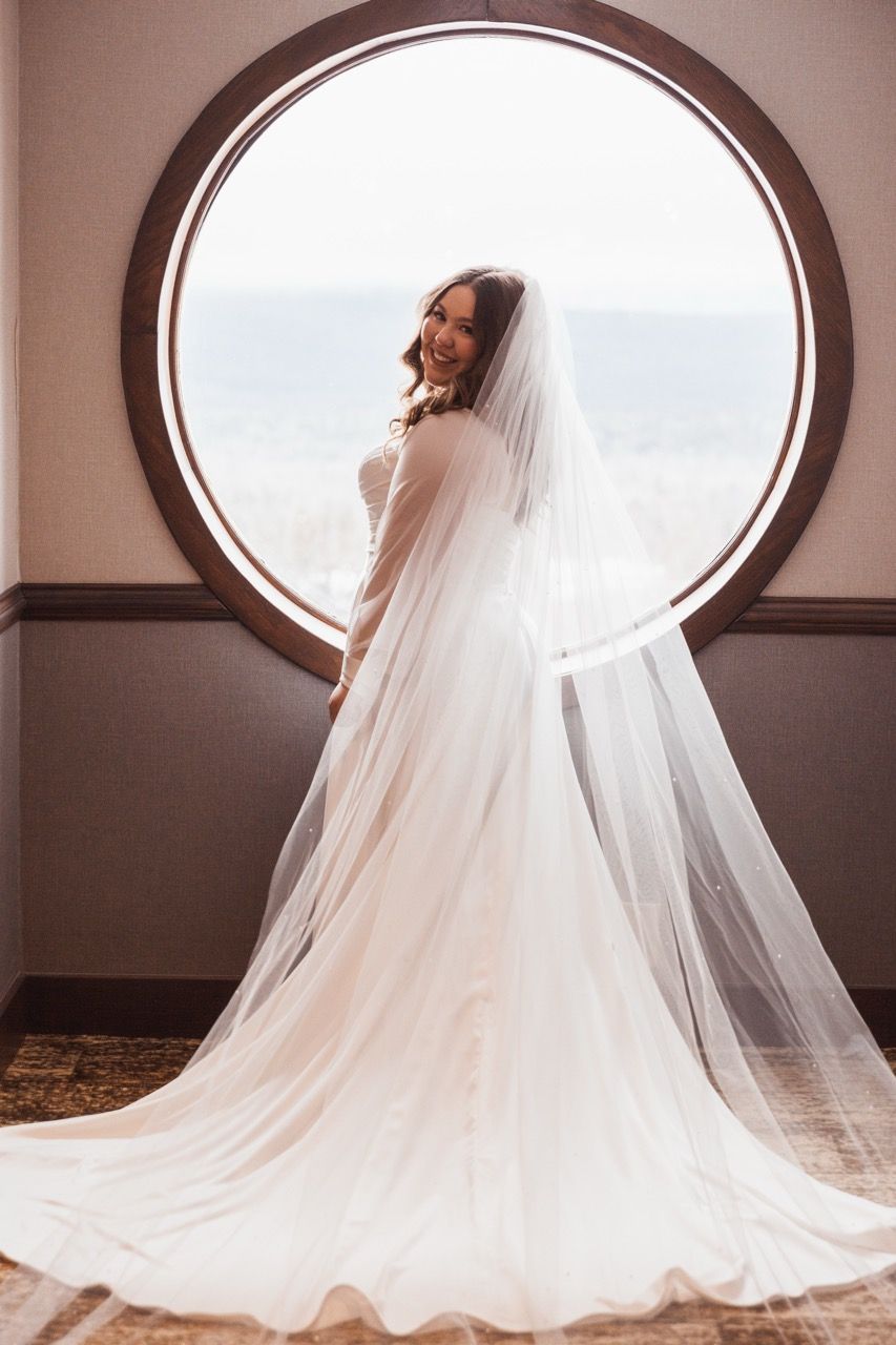 Bride in window for winter wedding at Sugarloaf Mountain Resort in Carrabassett Valley, Maine captured by illuminate the stars Photography