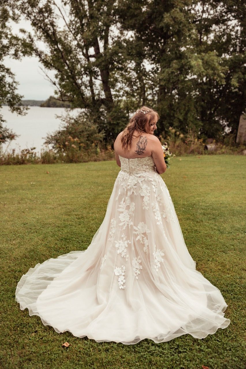 Bride showing off her dress after her fall wedding at The Lakeside Lodge in Sydney, Maine captured by illuminate the stars Photography