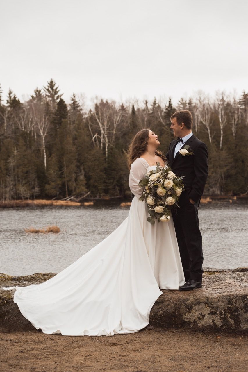 Couple and lake for winter wedding at Sugarloaf Mountain Resort in Carrabassett Valley, Maine captured by illuminate the stars Photography