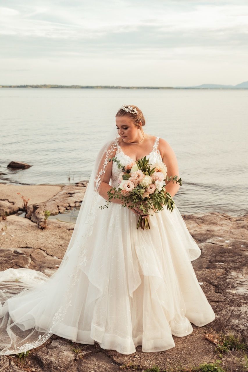 Bride in front of a lake during her fall wedding at Camp Dudley in Westport, New York captured by illuminate the stars Photography