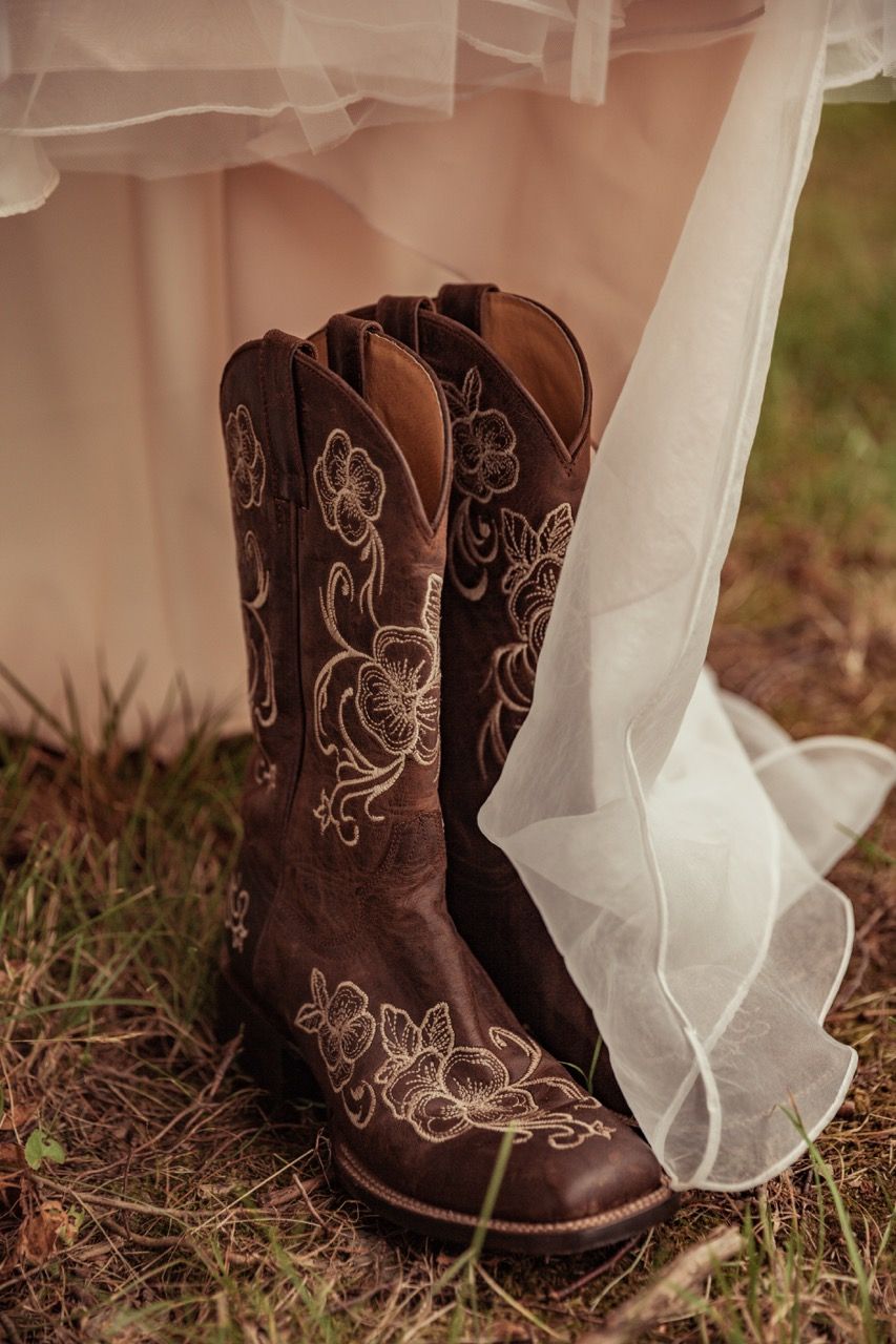 Bride's boots and dress before fall wedding at The Lakeside Lodge in Sydney, Maine captured by illuminate the stars Photography