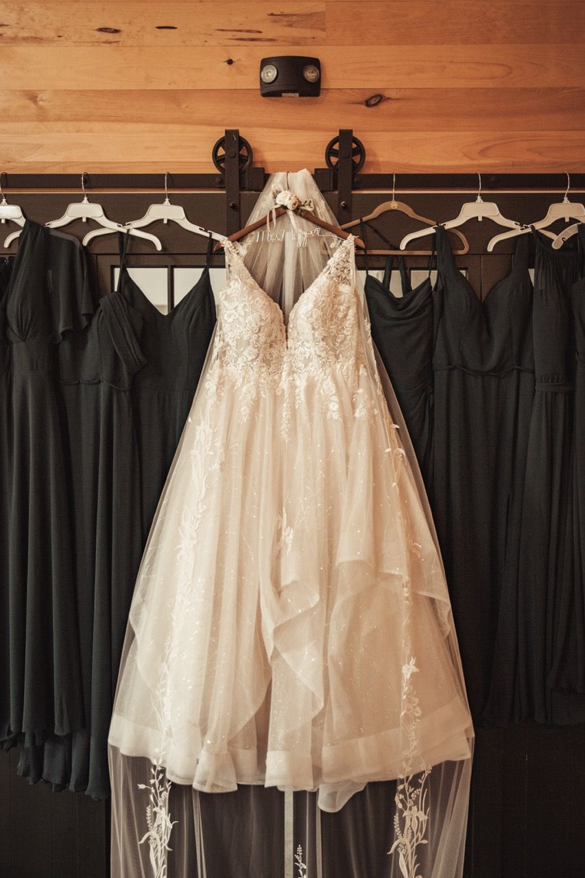 Wedding dresses hanging before fall wedding at Camp Dudley in Westport, New York captured by illuminate the stars Photography